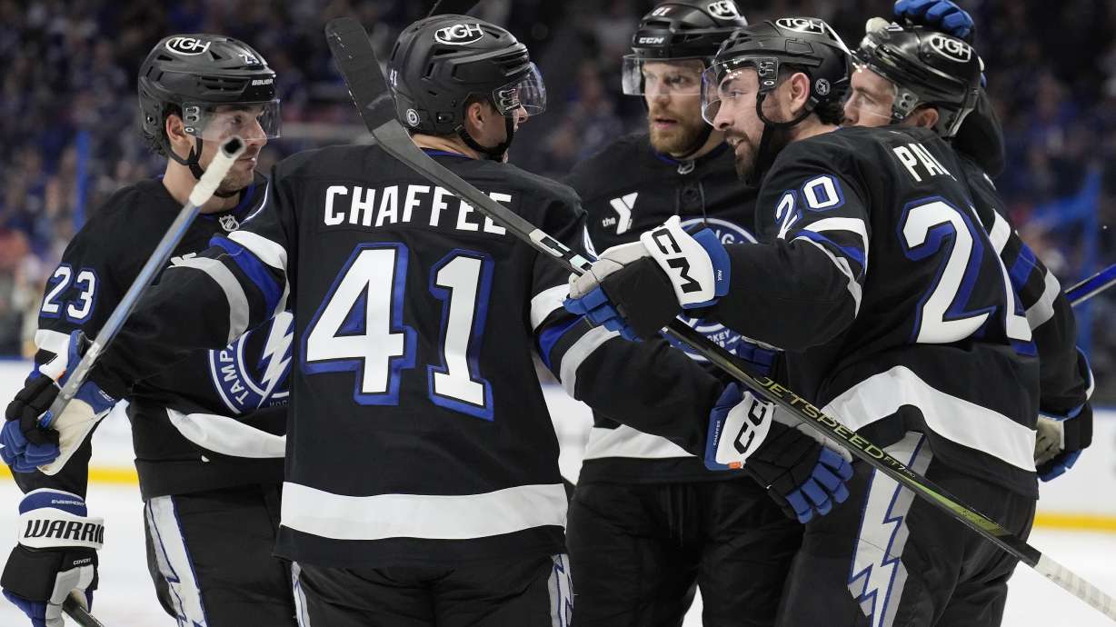 Tampa Bay Lightning right wing Mitchell Chaffee (41) celebrates his goal against the Washington Capitals with left wing Nick Paul (20), center Michael Eyssimont (23) and defenseman Erik Cernak (81) during the second period of an NHL hockey game Saturday, Oct. 26, 2024, in Tampa, Fla.
