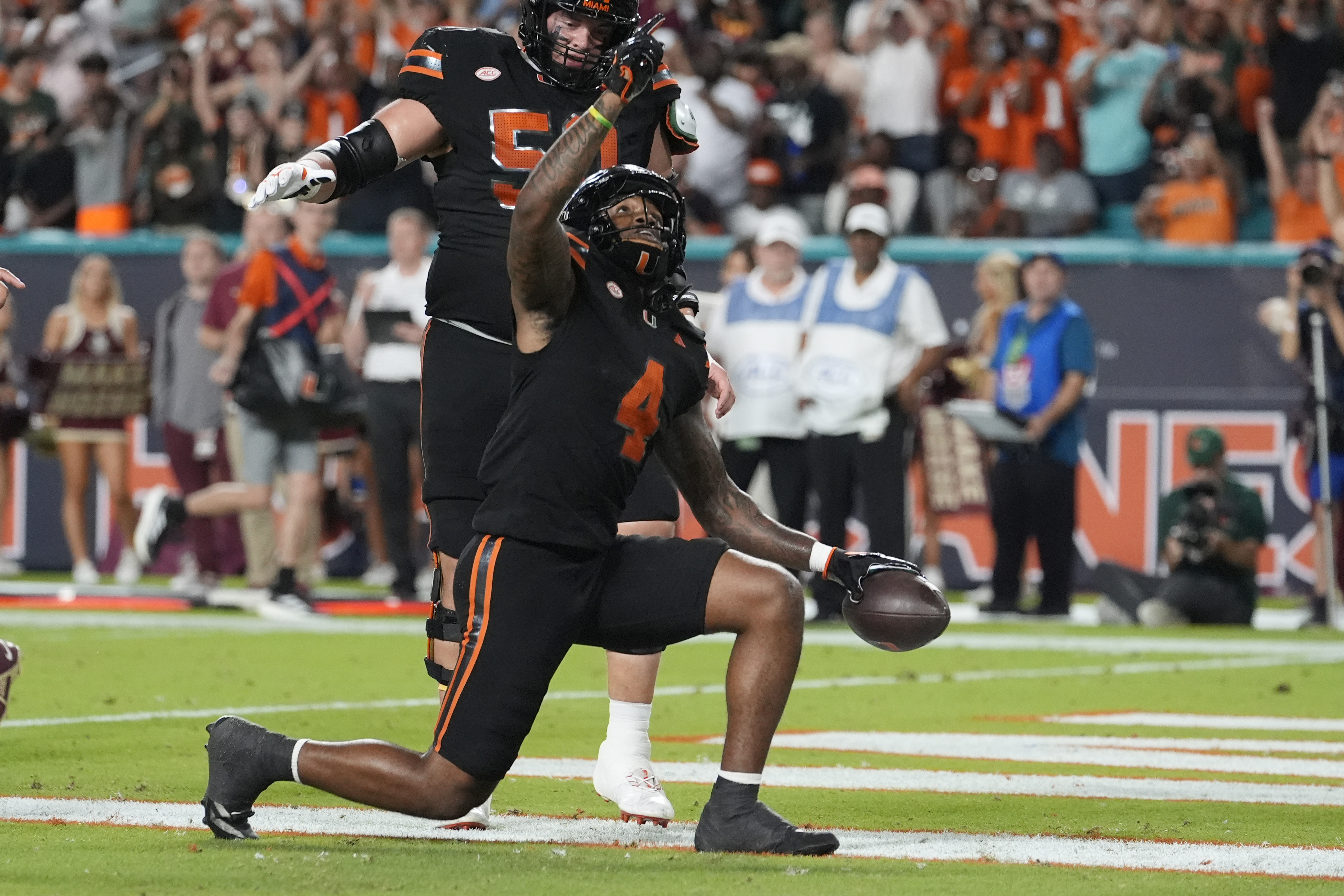 Miami running back Mark Fletcher Jr. (4) reacts after scoring a touchdown during the first half of an NCAA college football game against Florida State, Saturday, Oct. 26, 2024, in Miami Gardens, Fla. 