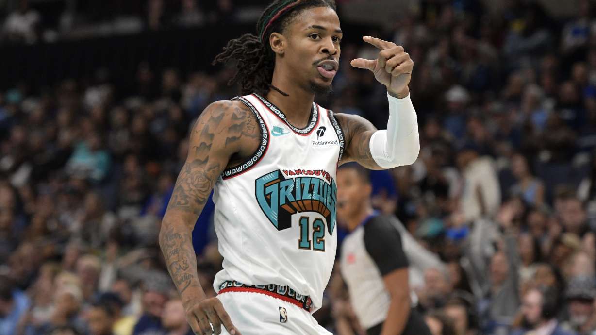 Memphis Grizzlies guard Ja Morant (12) gestures to Orlando Magic players in the first half of an NBA basketball game Saturday, Oct. 26, 2024, in Memphis, Tenn.
