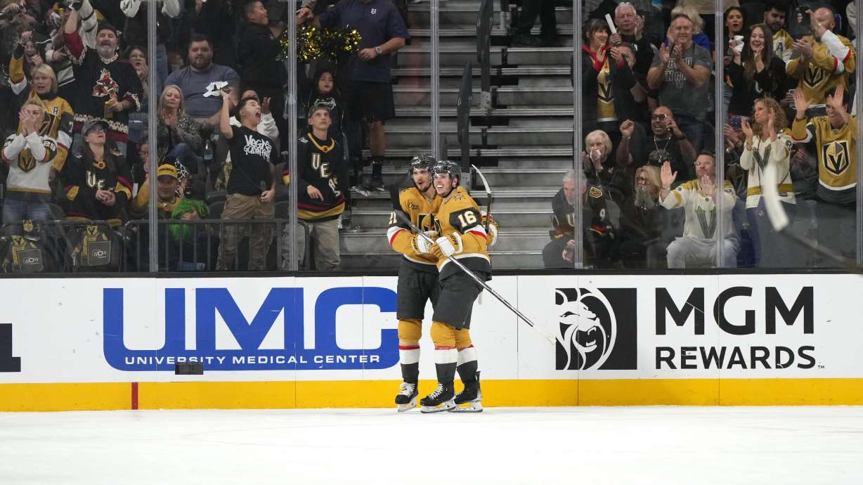 Vegas Golden Knights center Brett Howden (21), left, celebrates with left wing Pavel Dorofeyev (16) after scoring a goal against the San Jose Sharks during the first period of an NHL hockey game Saturday, Oct. 26, 2024, in Las Vegas.