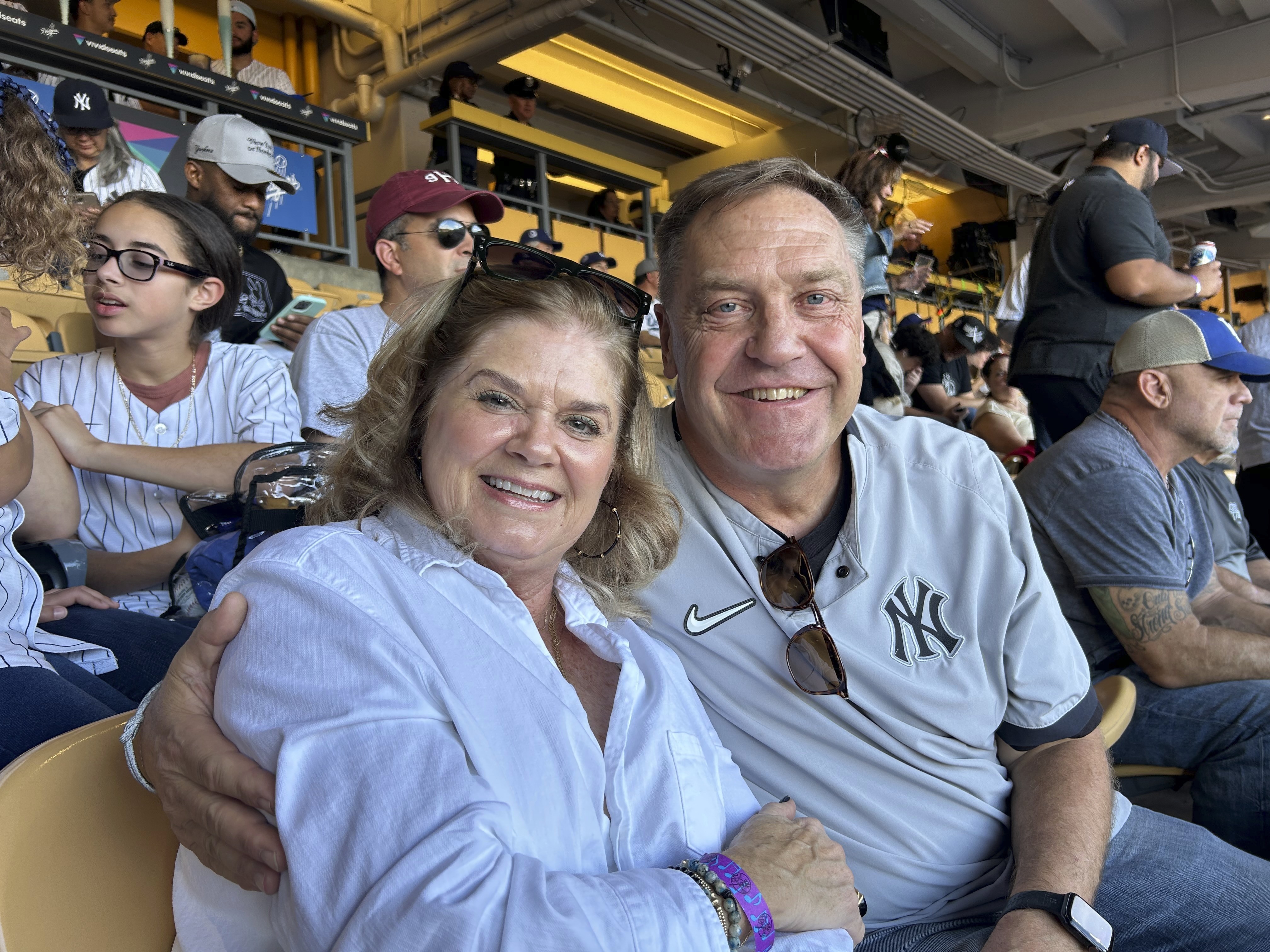 Dwight and Renee Schmidt, parents of New York Yankees pitcher Clarke Schmidt, sit in the stands before Game 2 of the baseball World Series against the Los Angeles Dodgers, Saturday, Oct. 26, 2024, in Los Angeles.