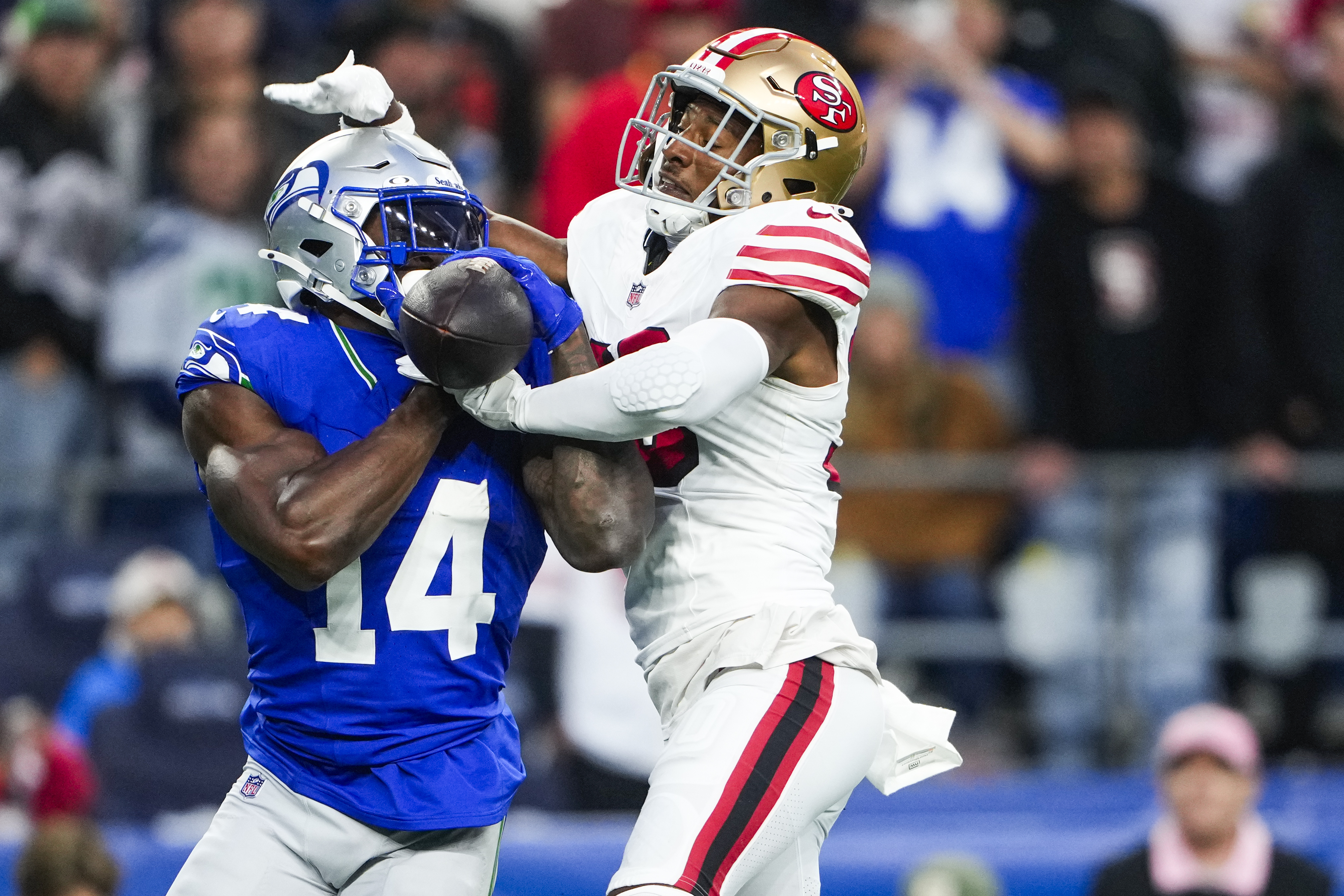 San Francisco 49ers safety George Odum, right, forces an incomplete pass against Seattle Seahawks wide receiver DK Metcalf (14) during the first half of an NFL football game Thursday, Oct. 10, 2024 in Seattle. 