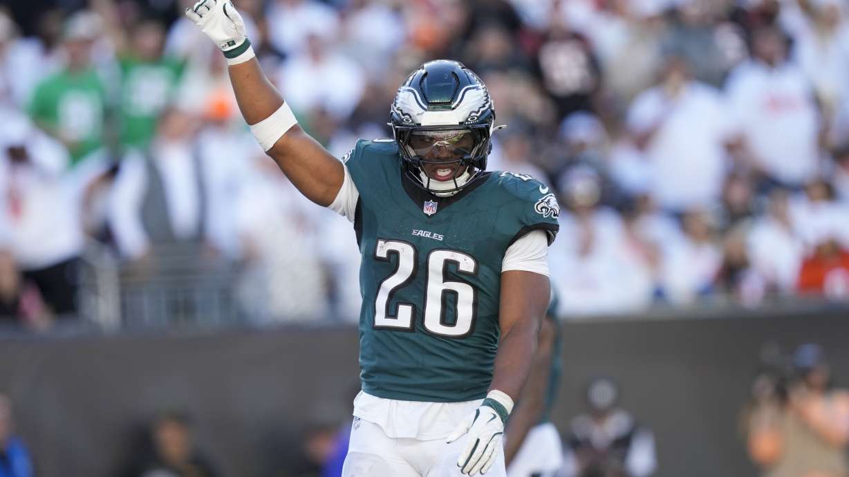 Philadelphia Eagles running back Saquon Barkley (26) reacts after teammate Jalen Hurts (1) scored a touchdown against the Cincinnati Bengals during the second half of an NFL football game, Sunday, Oct. 27, 2024 in Cincinnati. The Eagles won 37-17.