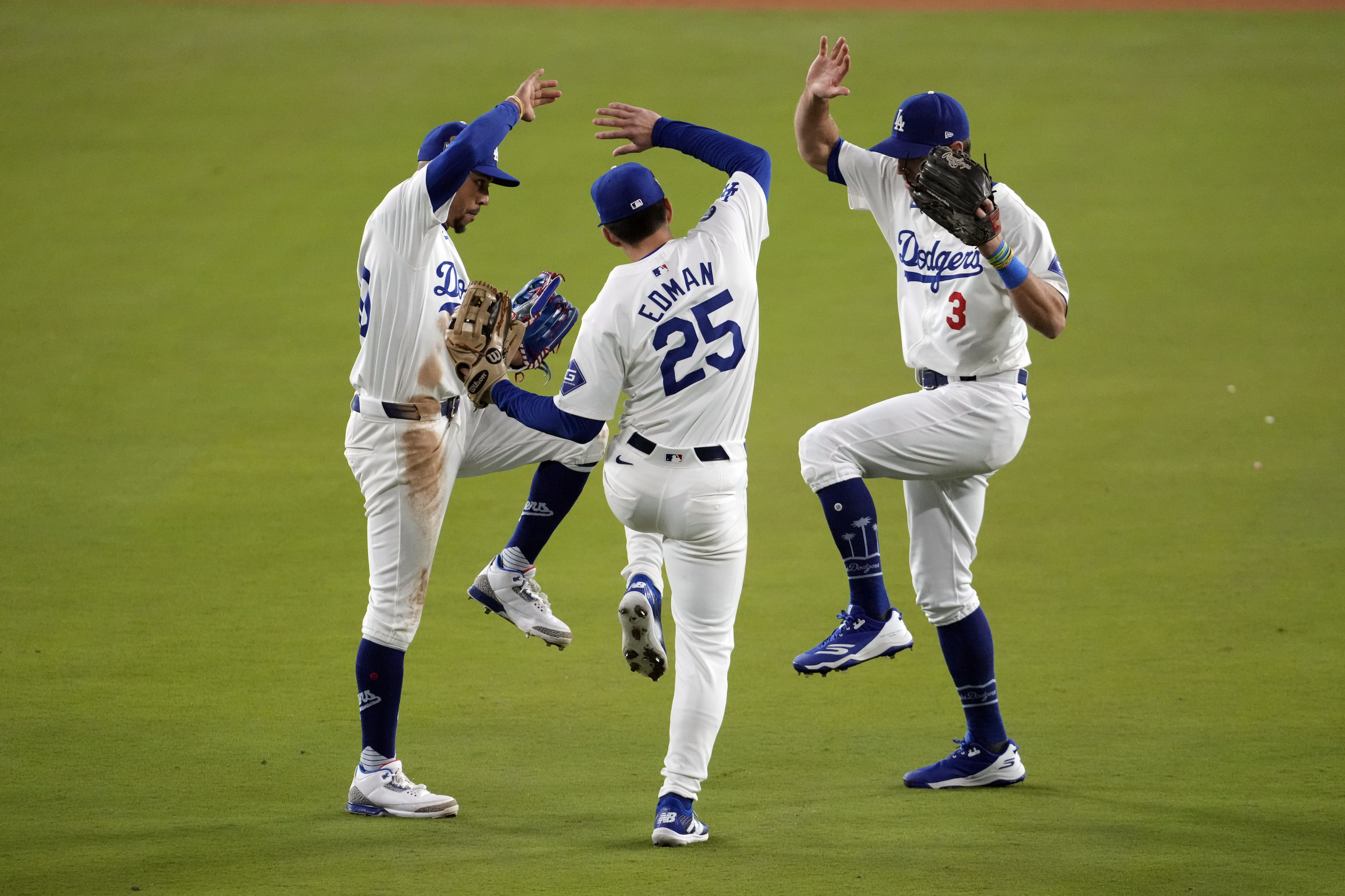 Los Angeles Dodgers Chris Taylor (3), Tommy Edman (25) and Mookie Betts celebrate after Game 2 of the baseball World Series against the New York Yankees, Saturday, Oct. 26, 2024, in Los Angeles. The Dodgers won 4-2.