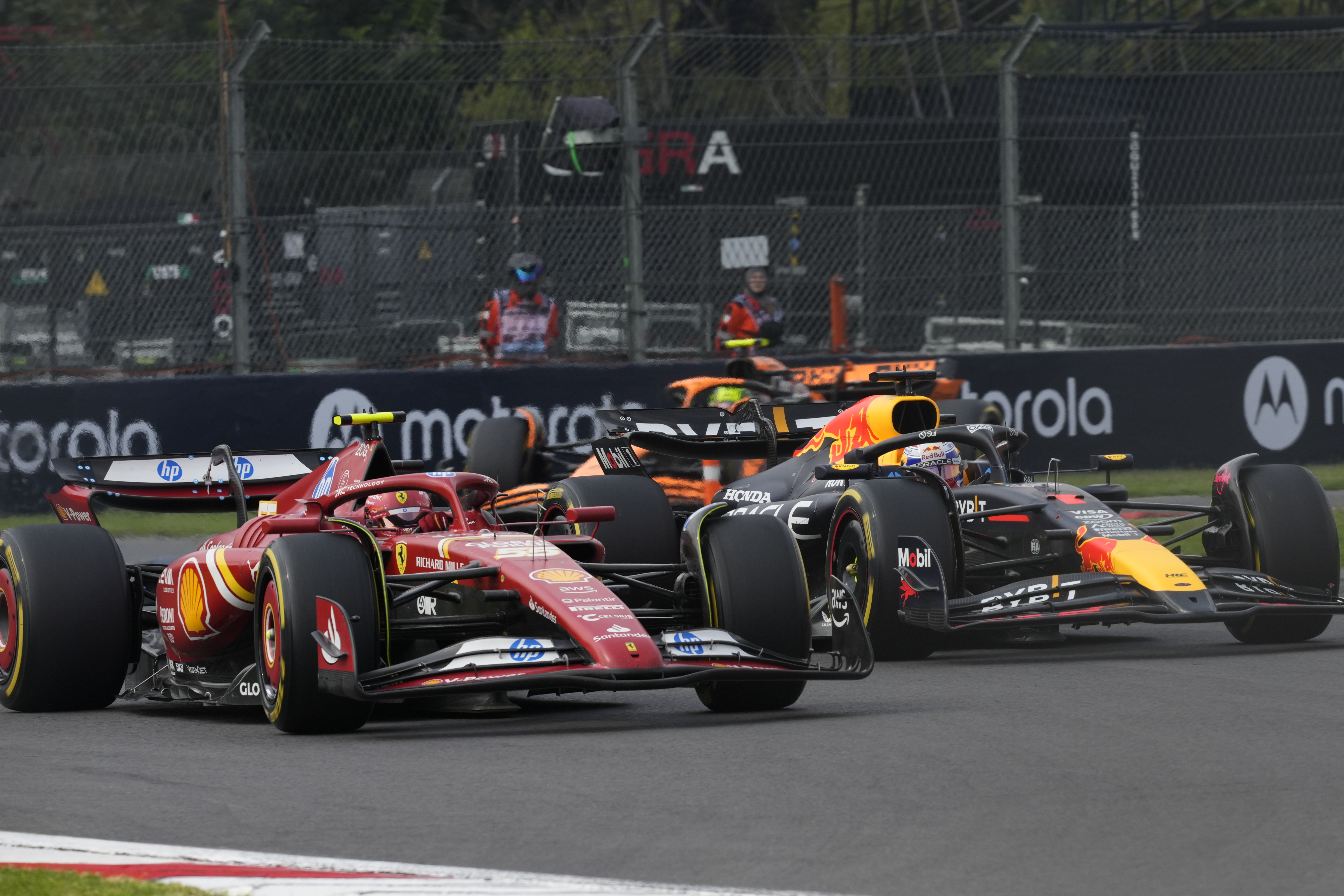 Carlos Sainz, of Spain, steers his Ferrari followed by Red Bull driver Max Verstappen of the Netherlands during the Formula One Mexico Grand Prix auto race at the Hermanos Rodriguez racetrack in Mexico City, Sunday, Oct. 27, 2024.