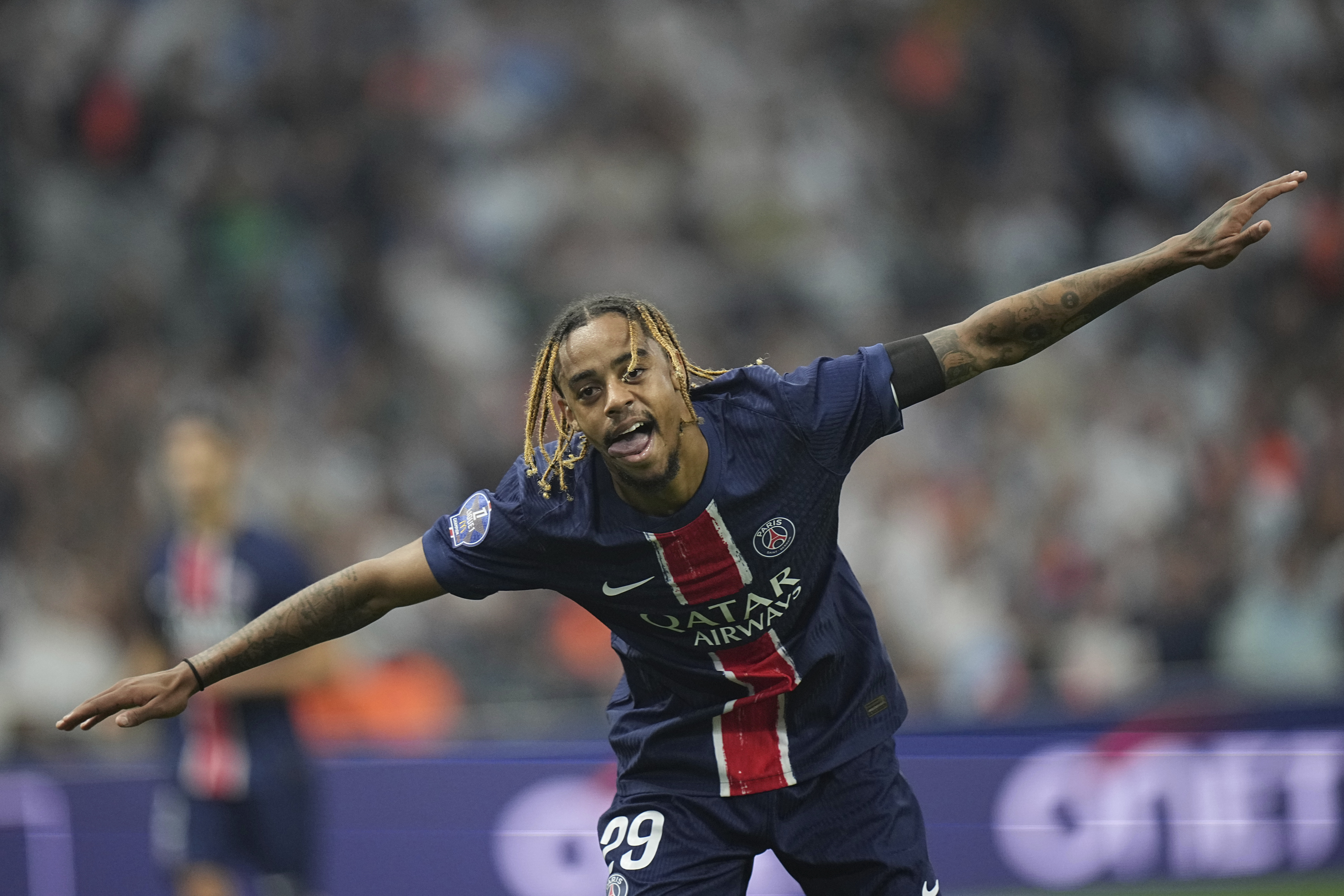 PSG's Bradley Barcola celebrates after scoring his side third goal during the League One soccer match between Marseille and Paris Saint-Germain, Sunday, Oct. 27, 2024 at the Velodrome stadium in Marseille, southern France.