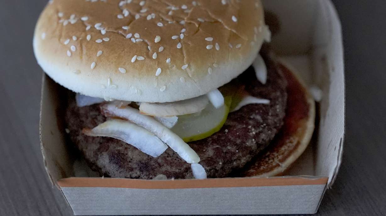 McDonald's says testing has ruled out beef patties as the source of the outbreak of E. coli poisoning tied to its Quarter Pounders.