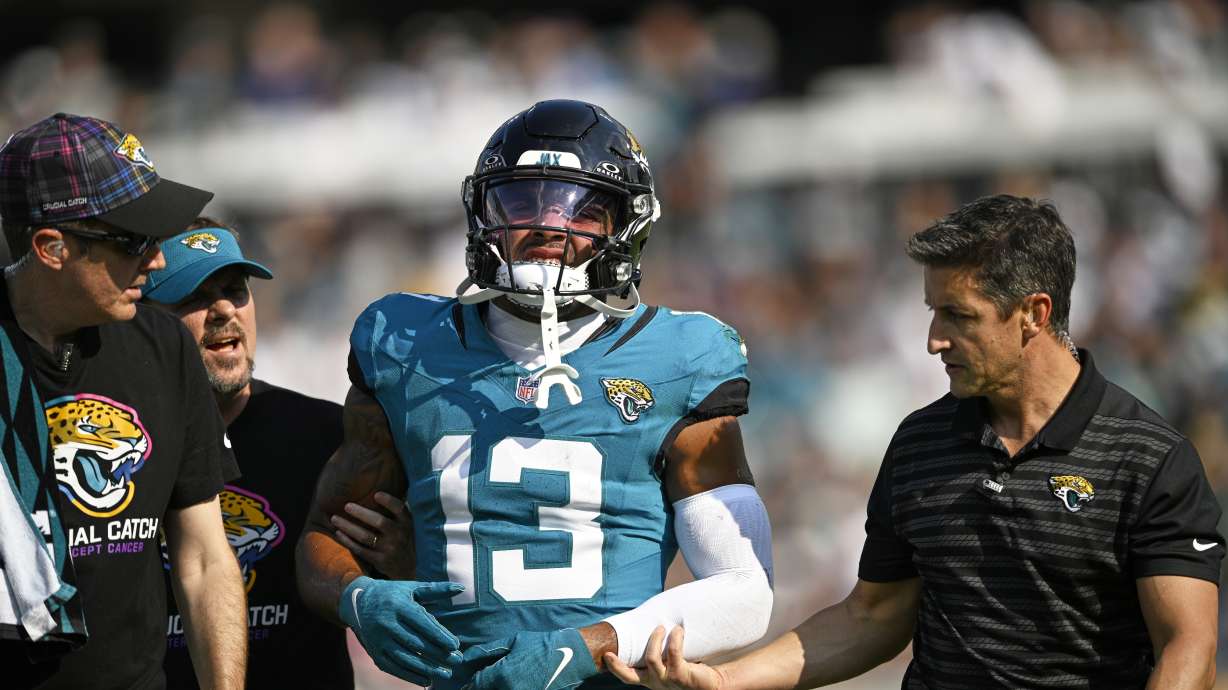 Jacksonville Jaguars' Christian Kirk is helped off the field during the second half of an NFL football game against the Green Bay Packers Sunday, Oct. 27, 2024, in Jacksonville, Fla.