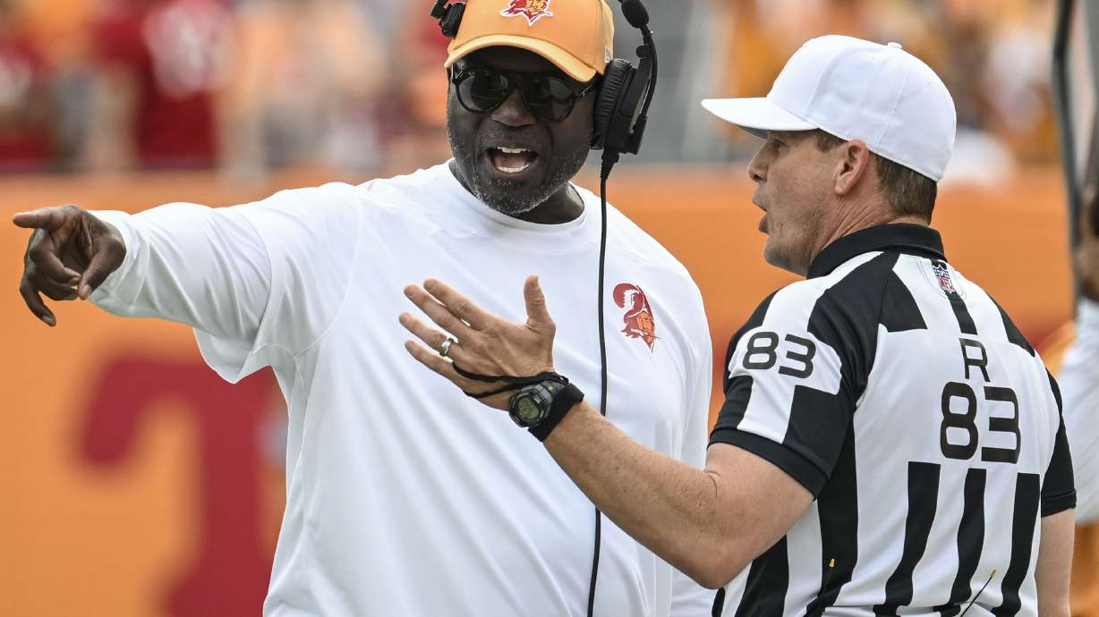 Tampa Bay Buccaneers head coach Todd Bowles speaks with referee Shawn Hochuli during the first half of an NFL football game against the Atlanta Falcons, Sunday, Oct. 27, 2024, in Tampa.