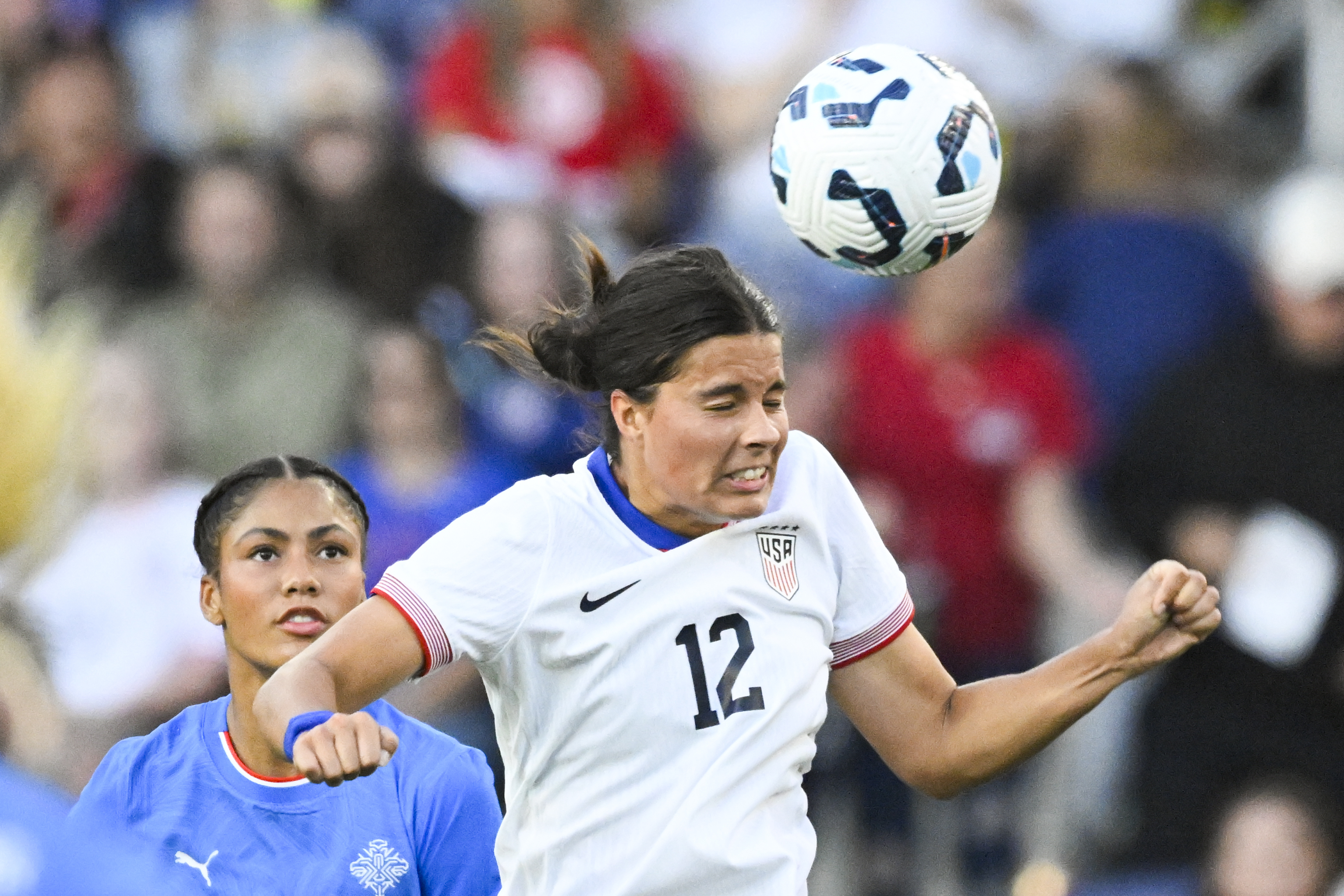 United States defender Emily Sams (12) gets a header in front of Iceland forward Sveindís Jane Jónsdóttir, left, during the first half of an international friendly women's soccer match Sunday, Oct. 27, 2024, in Nashville, Tenn. 