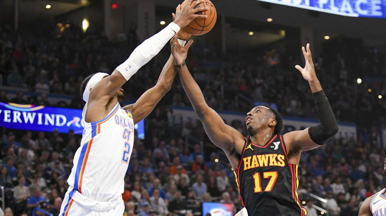 Oklahoma City Thunder guard Shai Gilgeous-Alexander (2) steals a pass from Atlanta Hawks forward Onyeka Okongwu (17) during the first half of an NBA basketball game, Sunday, Oct. 27, 2024, in Oklahoma City.