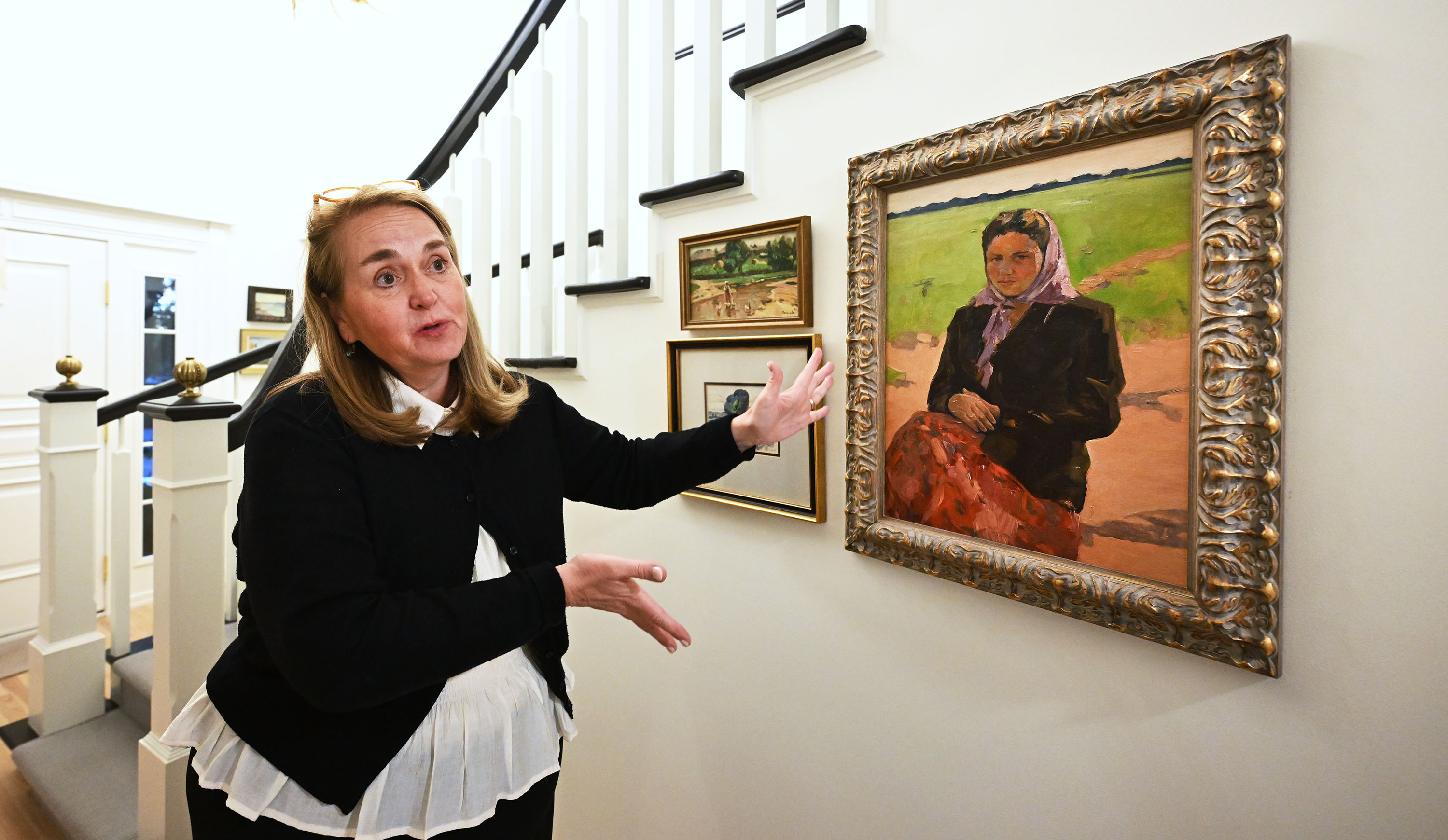 Mary Milliner shows one of her favorites by Soviet Ukrainian artist Anatoly Shkurko that she has in her home in Holladay as she and and her sisters Sarah Dansie and Marta Dansie talk about their work to import art from Ukraine to raise money for the war effort on Sept. 17.