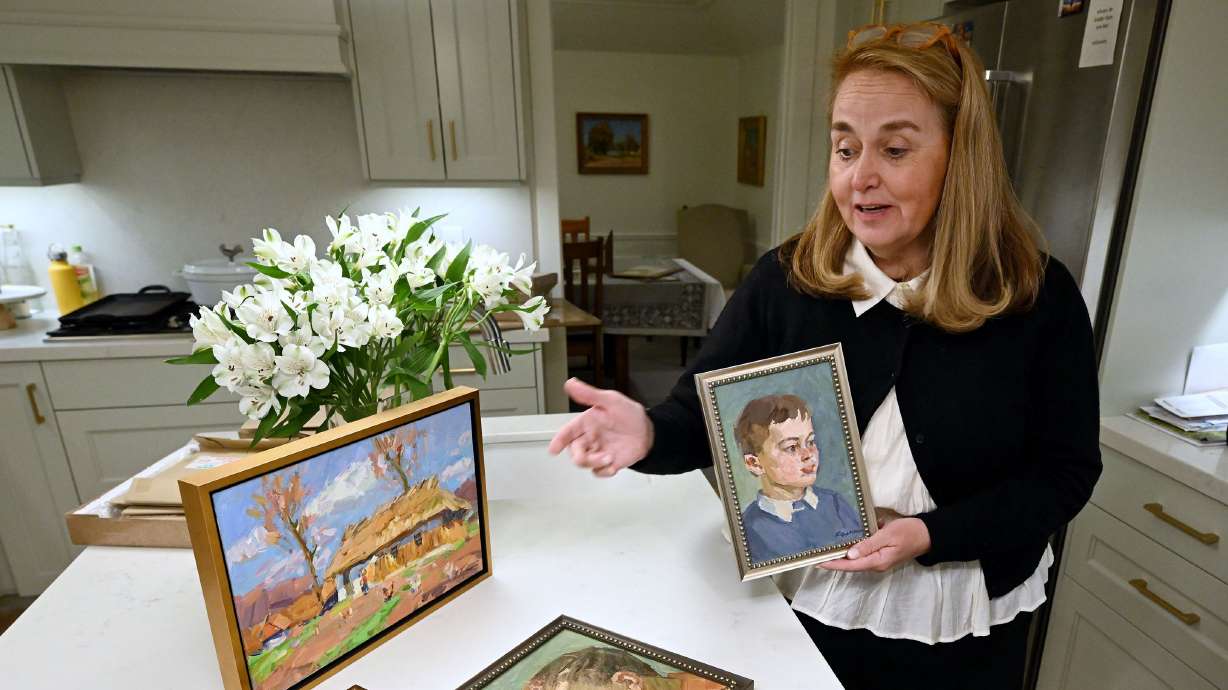 Mary Milliner talks about paintings by artists V.A. Kolesnik and Vyacheslav as she and her sisters Marta Dansie and Sarah Dansie talk about their work to import art from Ukraine to raise money for the war effort at Mary’s Holladay home on Sept. 17.