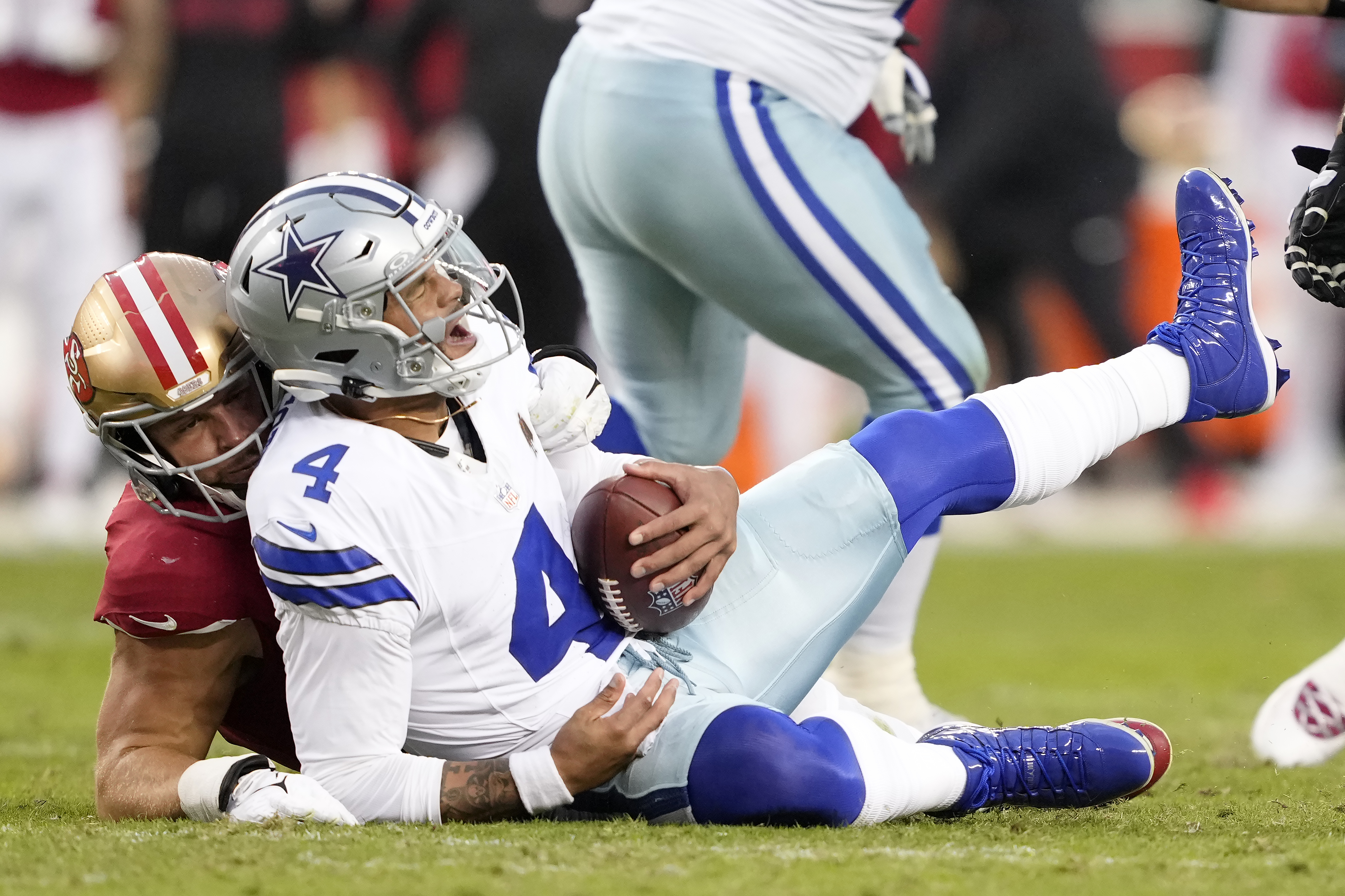 Dallas Cowboys quarterback Dak Prescott (4) reacts after being sacked by San Francisco 49ers defensive end Nick Bosa, left, during the first half of an NFL football game in Santa Clara, Calif., Sunday, Oct. 27, 2024.