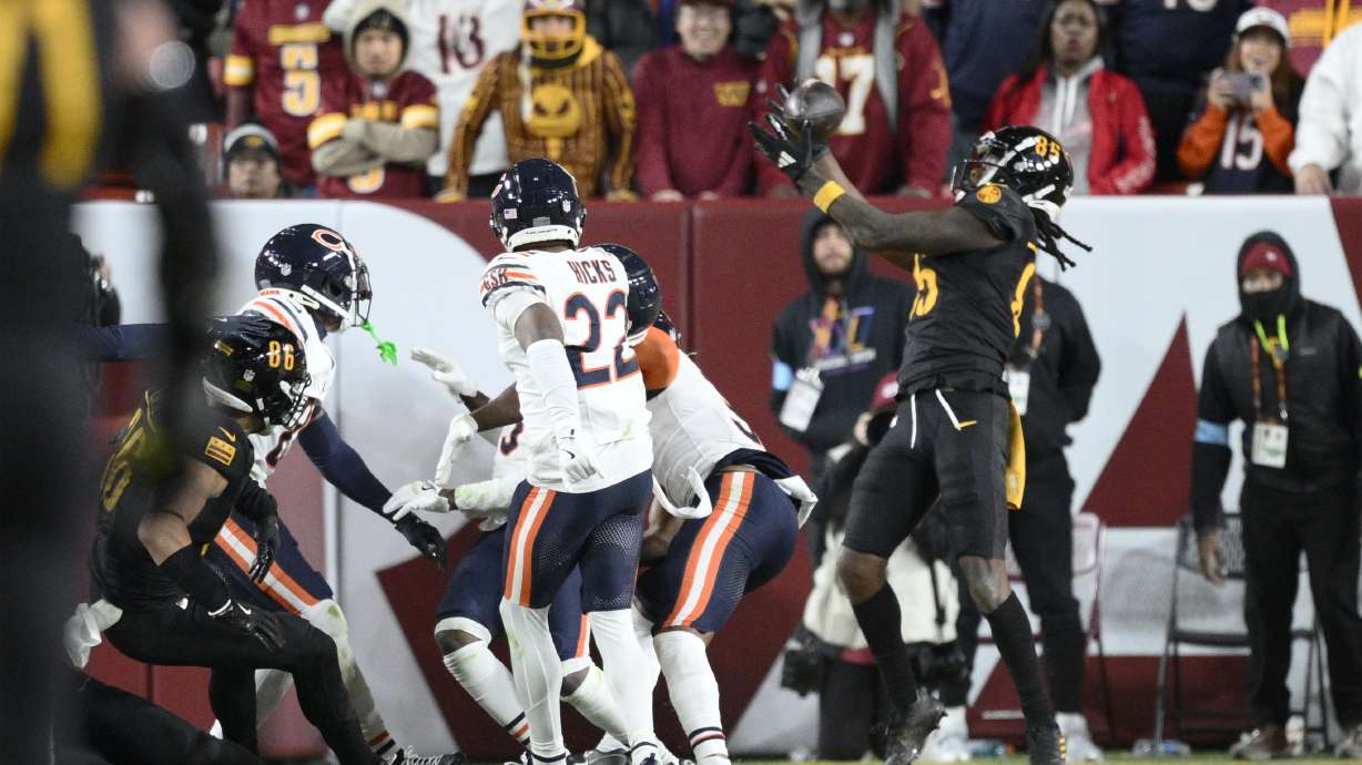Washington Commanders wide receiver Noah Brown (85) catches a 52-yard touchdown pass in the end zone as time expires to give the Commanders an 18-15 win over the Chicago Bears in an NFL football game Sunday, Oct. 27, 2024, in Landover, Md.