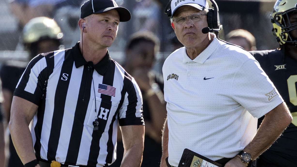 Central Florida head coach Gus Malzahn, right, stands next to a referee, left, while a play is reviewed during the first half of an NCAA college football game against BYU, Saturday, Oct. 26, 2024, in Orlando, Fla.