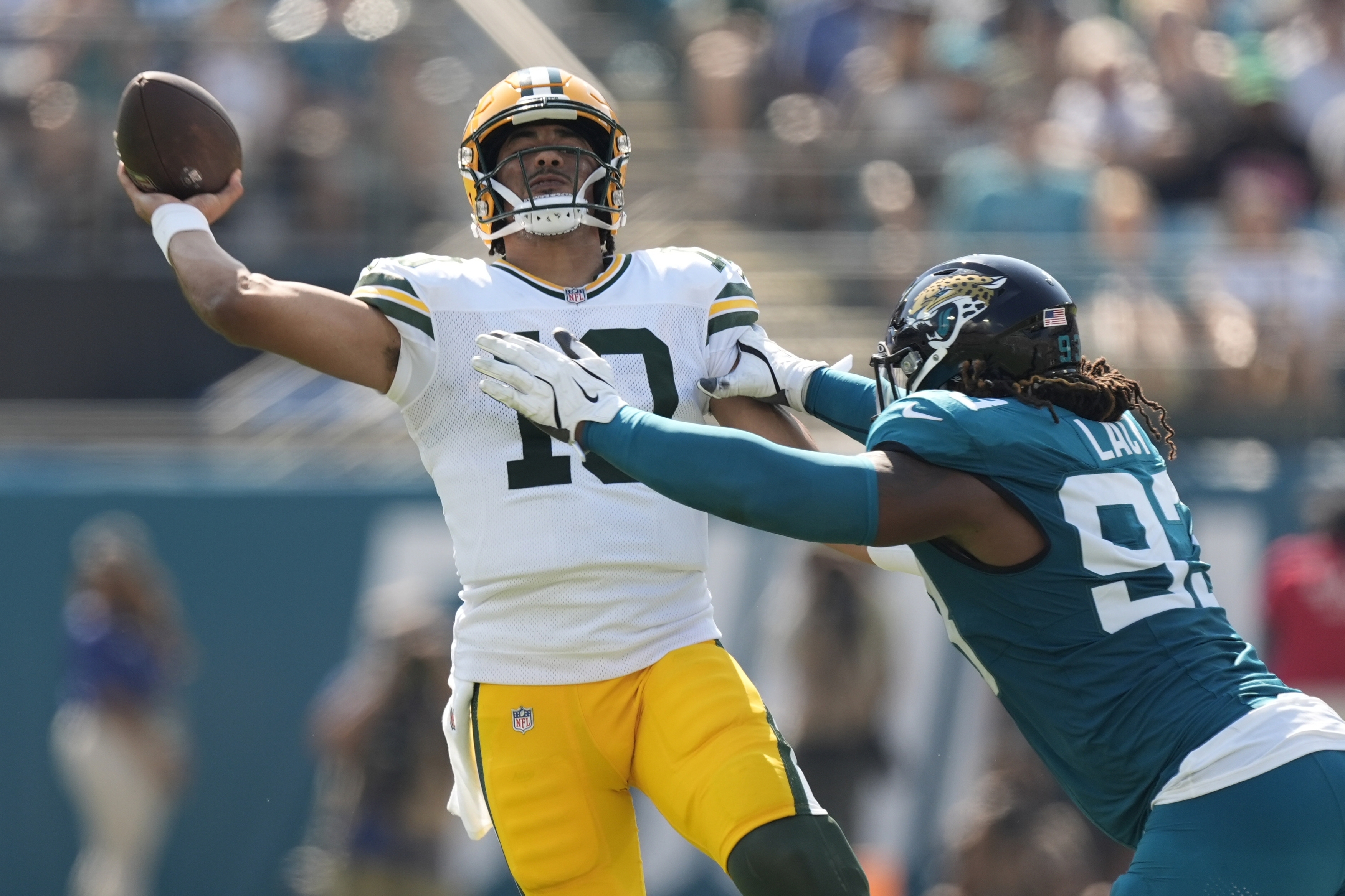 Green Bay Packers' Jordan Love throws while being hit by Jacksonville Jaguars' Tyler Lacy during the first half of an NFL football game Sunday, Oct. 27, 2024, in Jacksonville, Fla. 