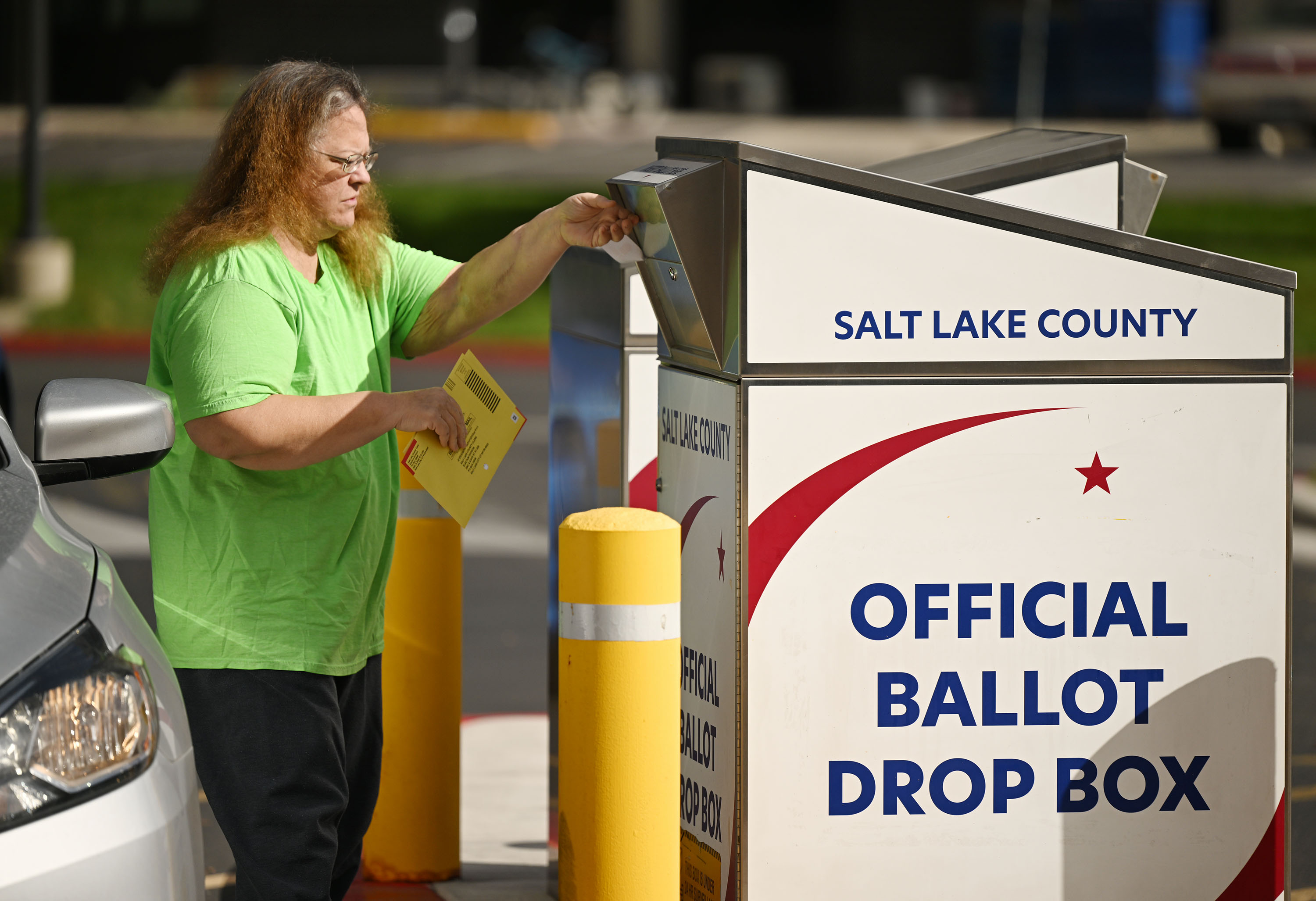 Susan Duncan, casts her ballot at a drop box at the Salt Lake County Government Center on Monday. Nearly 400,000 Utahns had already cast their ballot as of Monday morning, according to Utah Lt. Gov. Deidre Henderson.