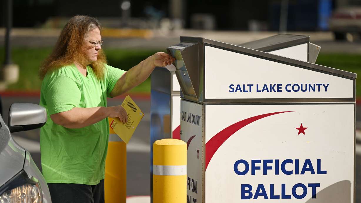 Susan Duncan, casts her ballot at a drop box at the Salt Lake County Government Center on Monday. Nearly 400,000 Utahns had already cast their ballot as of Monday morning, according to Utah Lt. Gov. Deidre Henderson.