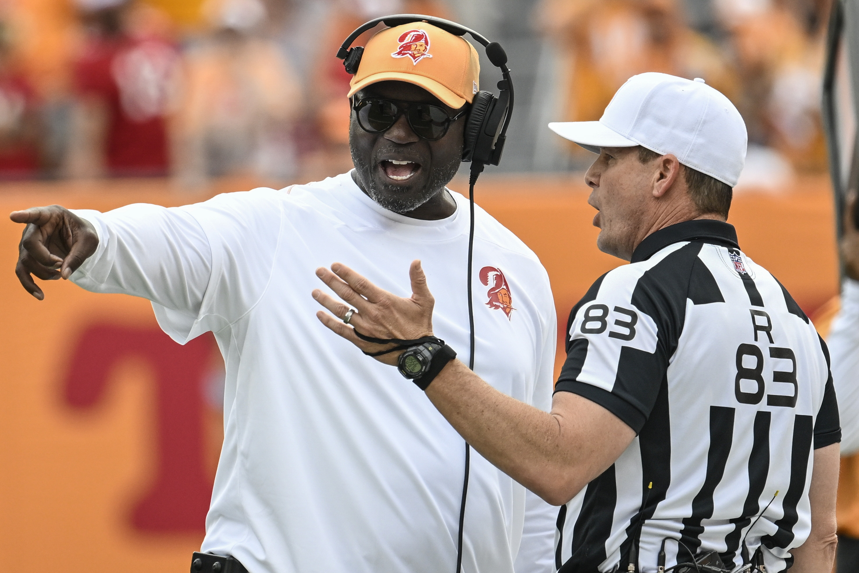 Tampa Bay Buccaneers head coach Todd Bowles speaks with referee Shawn Hochuli during the first half of an NFL football game against the Atlanta Falcons, Sunday, Oct. 27, 2024, in Tampa. 