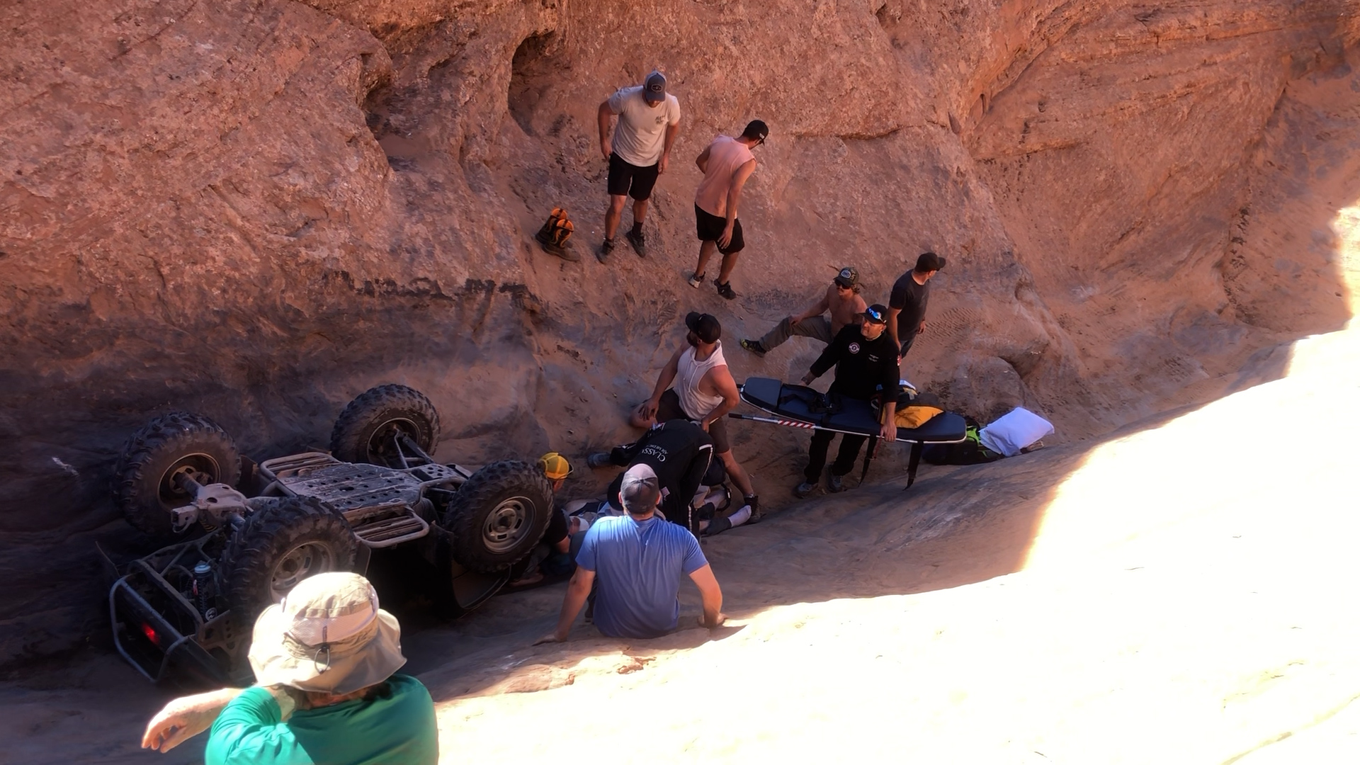 First responders and bystanders rush to the crash site near Moab on Saturday to help an injured ATV rider.