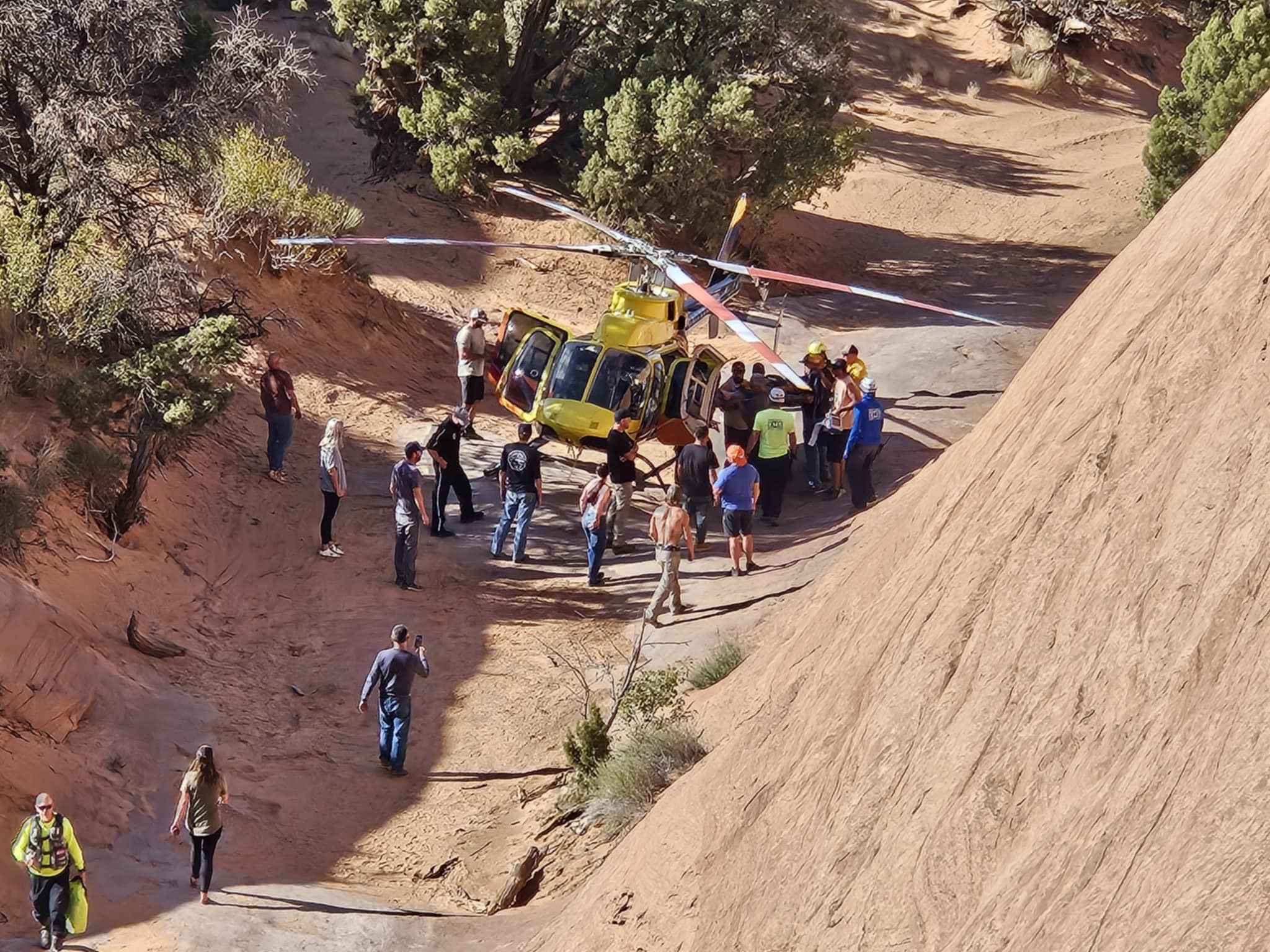 A group loads the hurt man into the helicopter near Moab on Saturday.