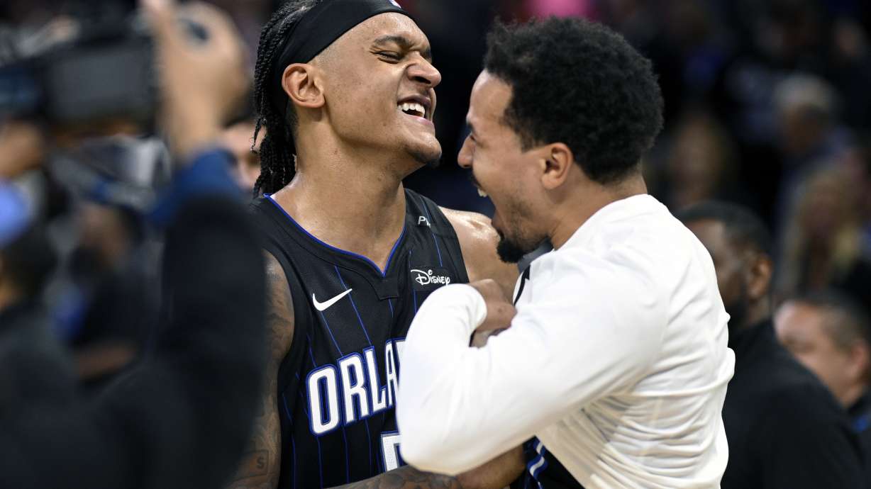 Orlando Magic forward Paolo Banchero, left, and guard Cole Anthony, right, celebrate after their win over the Indiana Pacers in an NBA basketball game, Monday, Oct. 28, 2024, in Orlando, Fla.