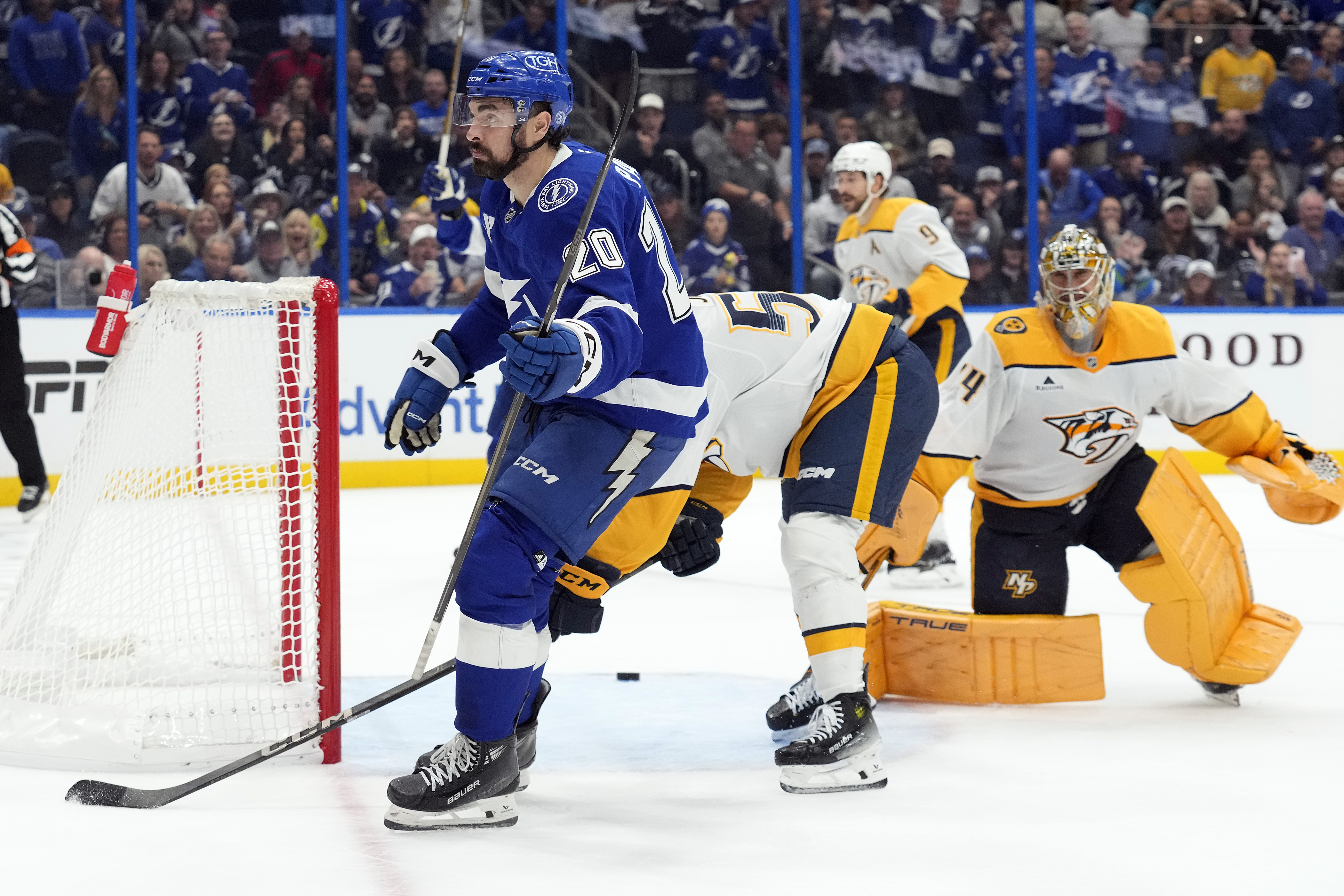 Tampa Bay Lightning left wing Nick Paul (20) celebrates after scoring past Nashville Predators goaltender Juuse Saros (74) and defenseman Roman Josi (59) during overtime in an NHL hockey game Monday, Oct. 28, 2024, in Tampa, Fla. 