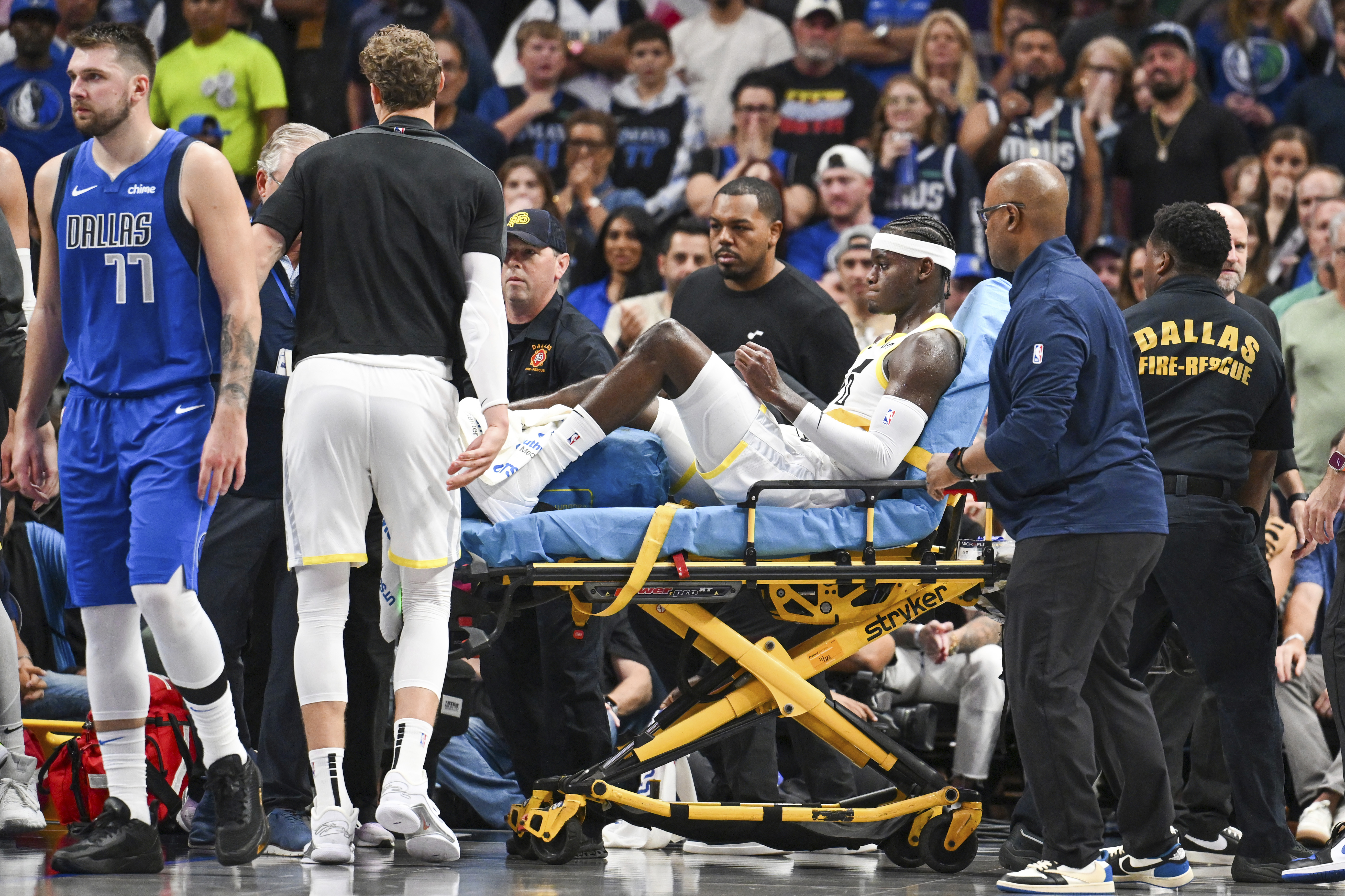 Utah Jazz forward Taylor Hendricks (0) is carried off by paramedics after sustaining an injury in the second half during an NBA basketball game against the Dallas Mavericks, Monday, Oct. 28, 2024, in Dallas.
