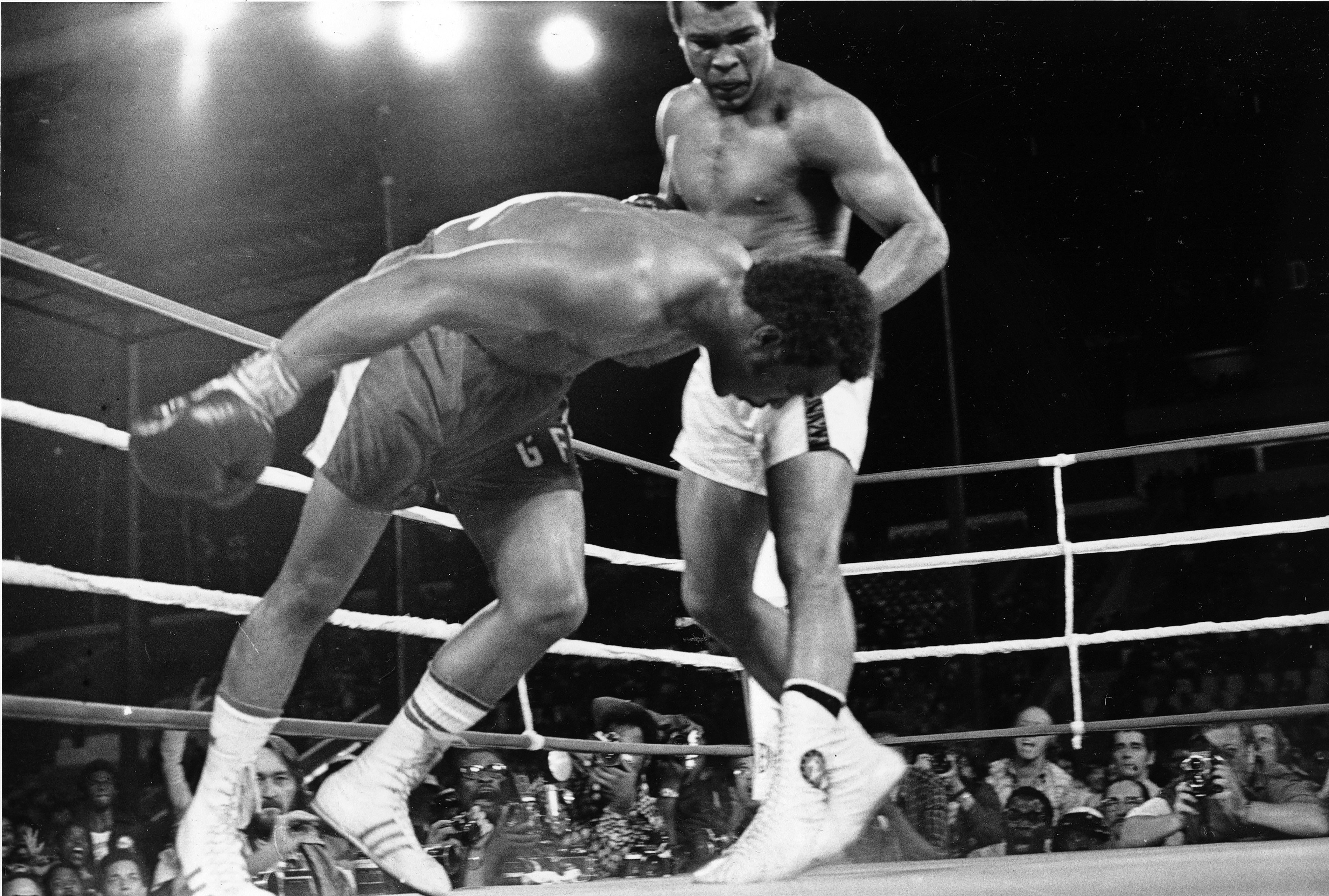 FILE - Challenger Muhammad Ali, right, watches as defending world champion George Foreman goes down to the canvas in the eighth round of their WBA/WBC championship match, on Oct. 30, 1974, in Kinshasa, Zaire. 