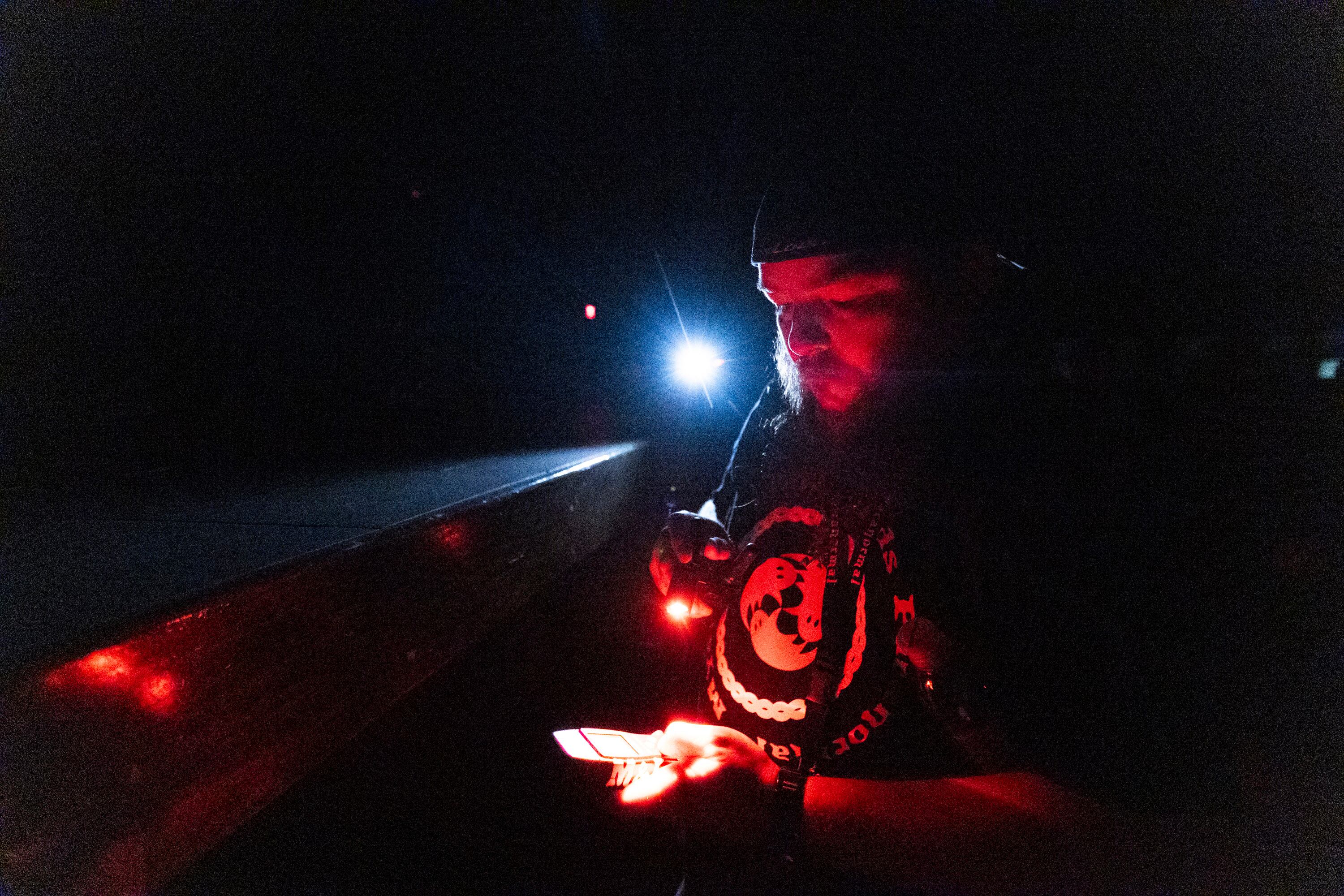 Corey Rue, an investigator with Mysteries and Legends Paranormal, sets up a movement detecting device while leading a group during a paranormal event hosted at the Great Saltair in Magna on Saturday.