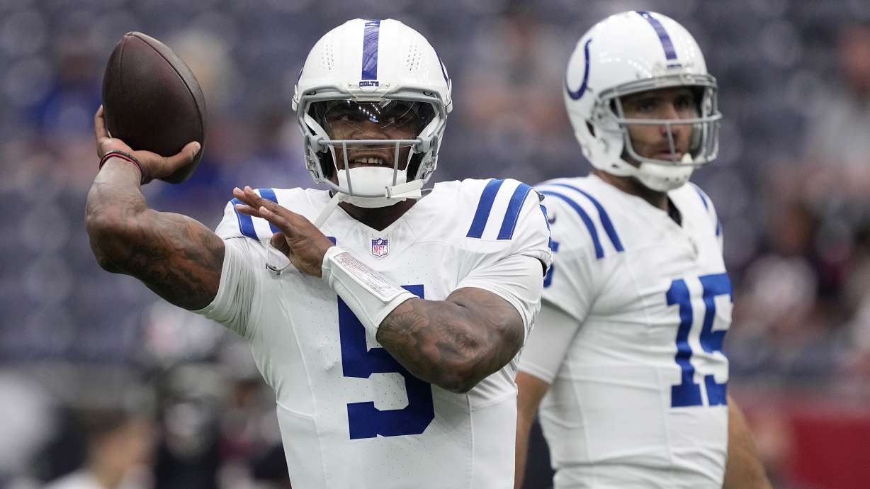 Indianapolis Colts quarterbacks Anthony Richardson (5) and Joe Flacco (15) warm up before an NFL football game against the Houston Texans, Sunday, Oct. 27, 2024, in Houston.