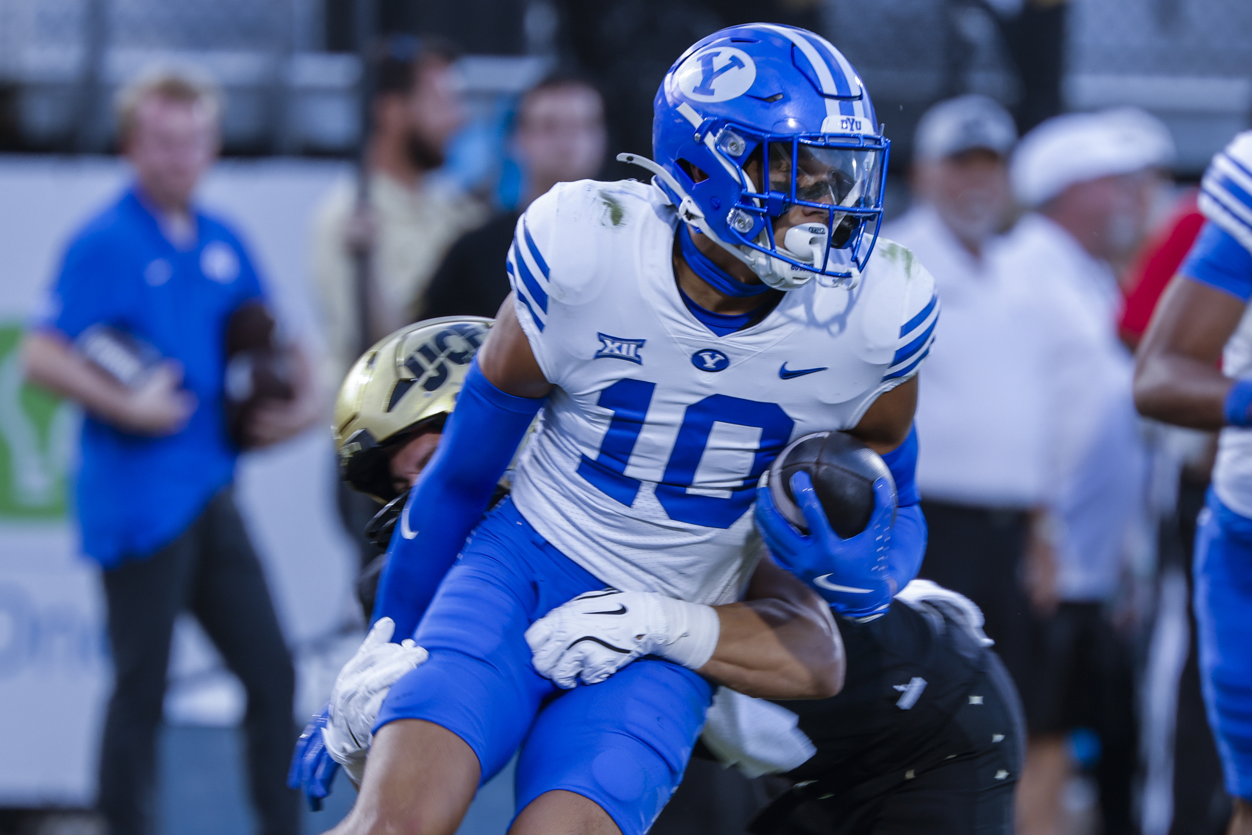 BYU safety Faletau Satuala (10) is tackled by tight end Evan Morris, behind, after interception during the second half of an NCAA college football game, Saturday, Oct. 26, 2024, in Orlando, Fla. 