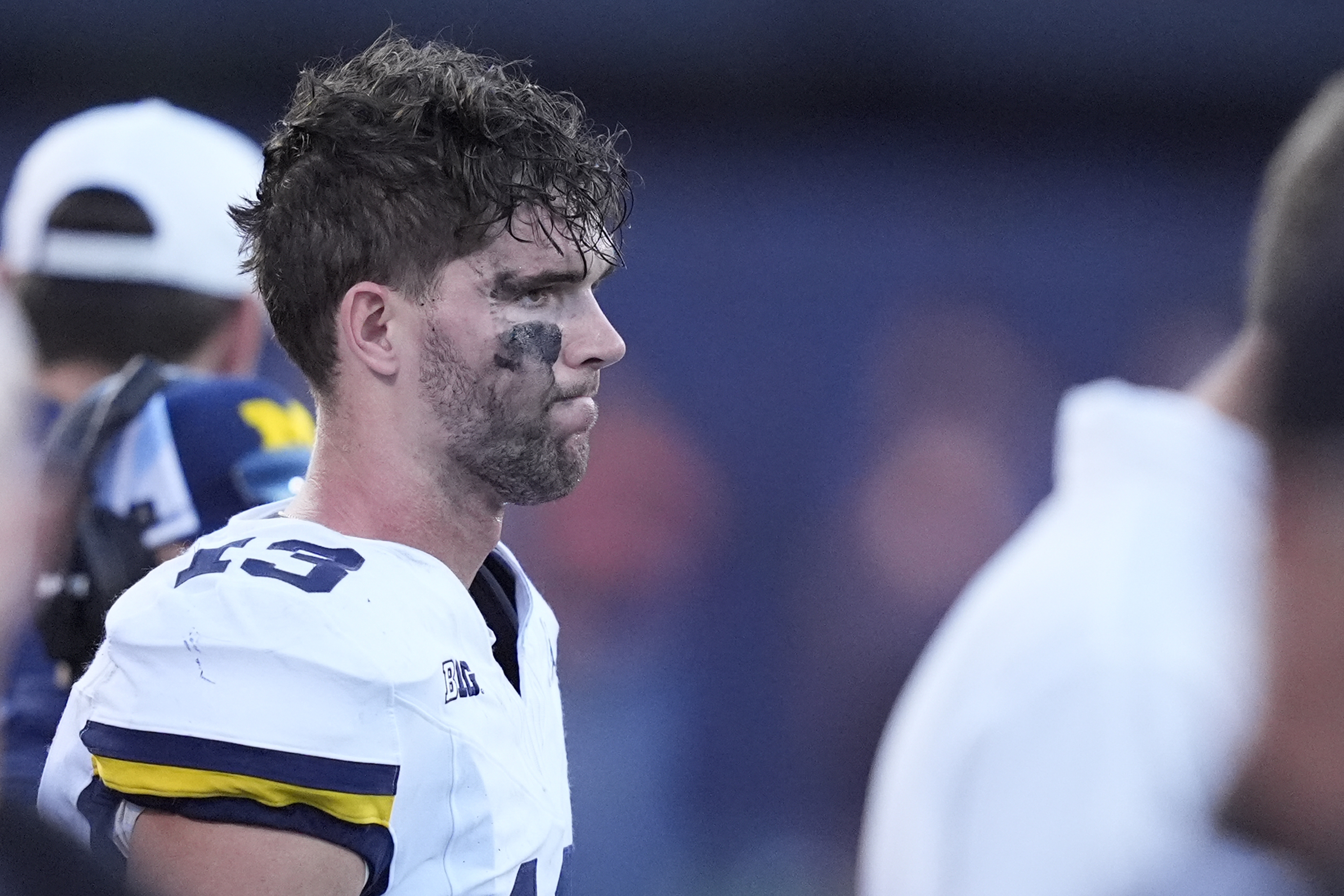 Michigan quarterback Jack Tuttle stands on the sidelines in the closing minutes of the team's 21-7 loss to Illinois in an NCAA college football game Saturday, Oct. 19, 2024, in Champaign, Ill.