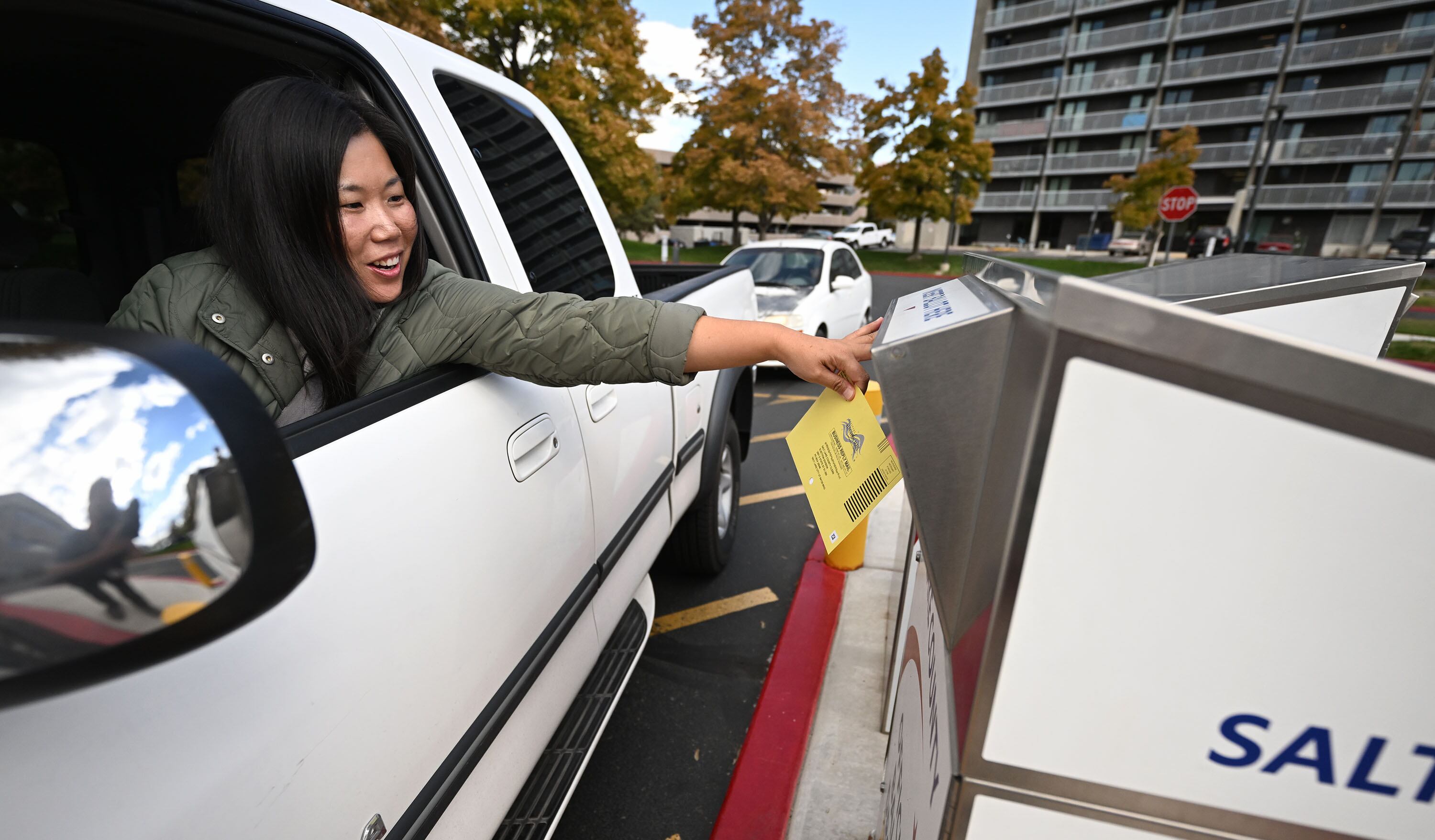 Teresa Liu, casts her ballot at a drop box at the Salt Lake County Government Center on Monday.