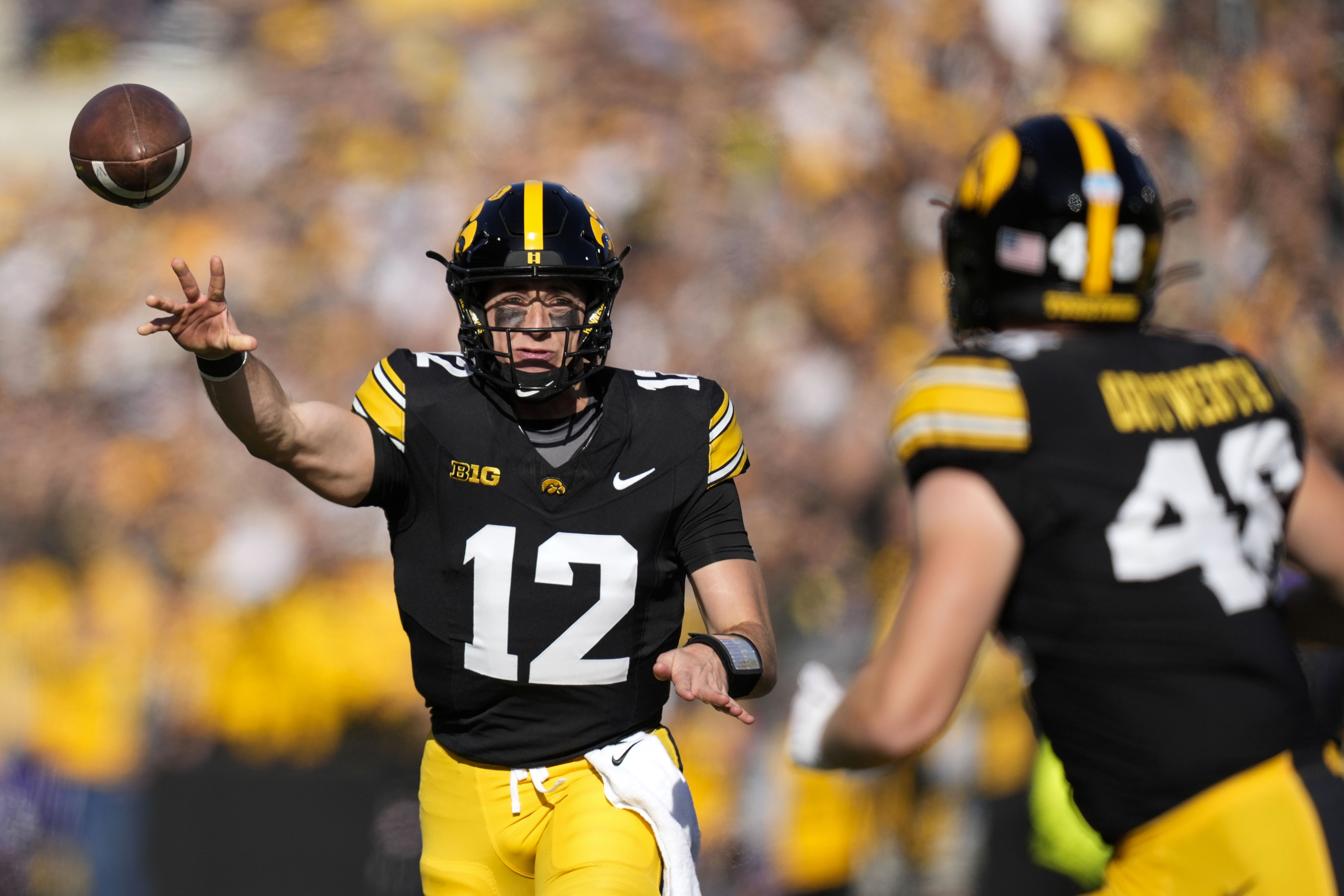 Iowa quarterback Cade McNamara (12) throws a pass during the first half of an NCAA college football game against Northwestern, Saturday, Oct. 26, 2024, in Iowa City, Iowa. 