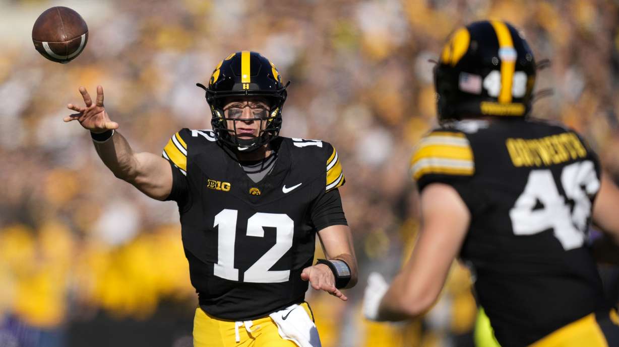 Iowa quarterback Cade McNamara (12) throws a pass during the first half of an NCAA college football game against Northwestern, Saturday, Oct. 26, 2024, in Iowa City, Iowa.