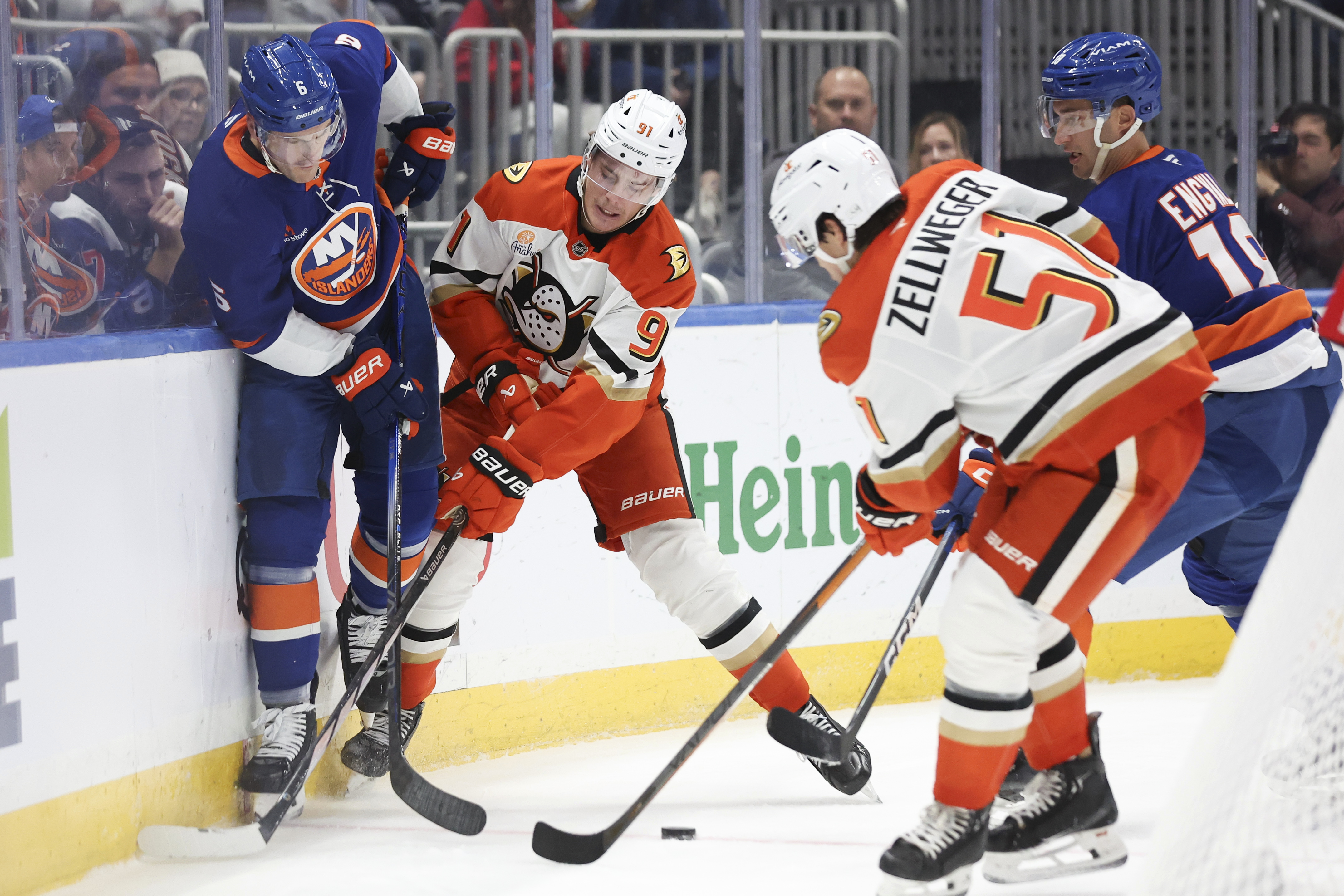 New York Islanders' Ryan Pulock and Anaheim Ducks' Leo Carlsson battle for the puck during the second period of an NHL hockey game, Tuesday, Oct. 29, 2024 in Elmont, N.Y.