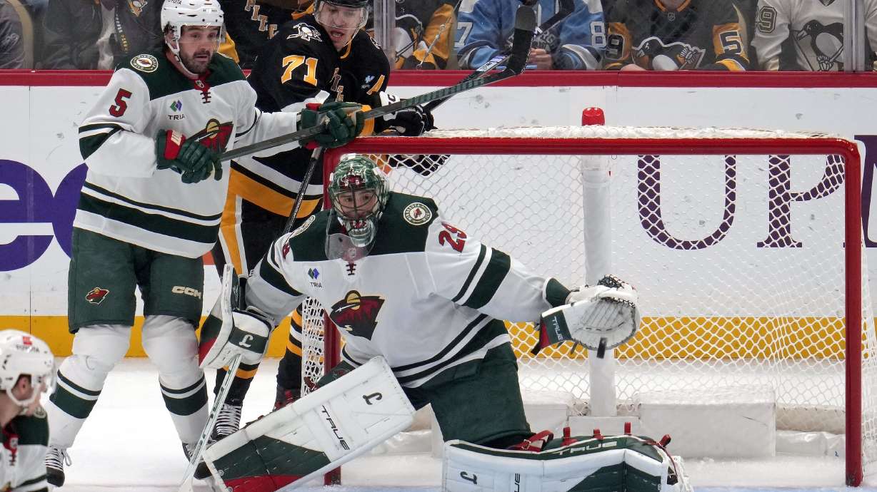 Pittsburgh Penguins' Rickard Rakell gets a shot past Minnesota Wild goaltender Marc-Andre Fleury for a goal as Jake Middleton (5) defends Evgeni Malkin (71) during the first period of an NHL hockey game in Pittsburgh, Tuesday, Oct. 29, 2024.