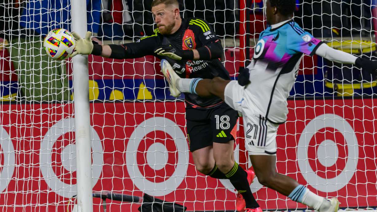 Real Salt Lake goalkeeper Zac MacMath (18) stops the shot from Minnesota United forward Bongokuhle Hlongwane (21) during an MLS soccer game, Tuesday, Oct. 29, 2024, in Salt Lake City.