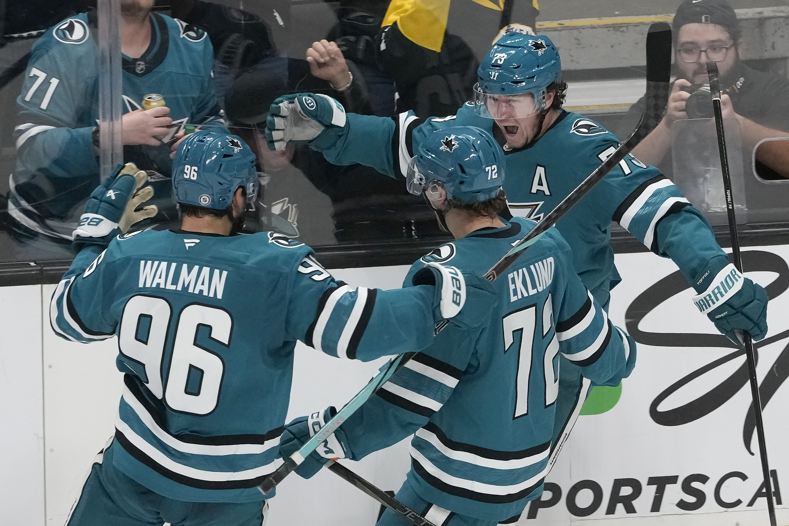 San Jose Sharks center Tyler Toffoli, right, celebrates with defenseman Jake Walman (96) and left wing William Eklund (72) after scoring against the Los Angeles Kings during the third period of an NHL hockey game in San Jose, Calif., Tuesday, Oct. 29, 2024. 