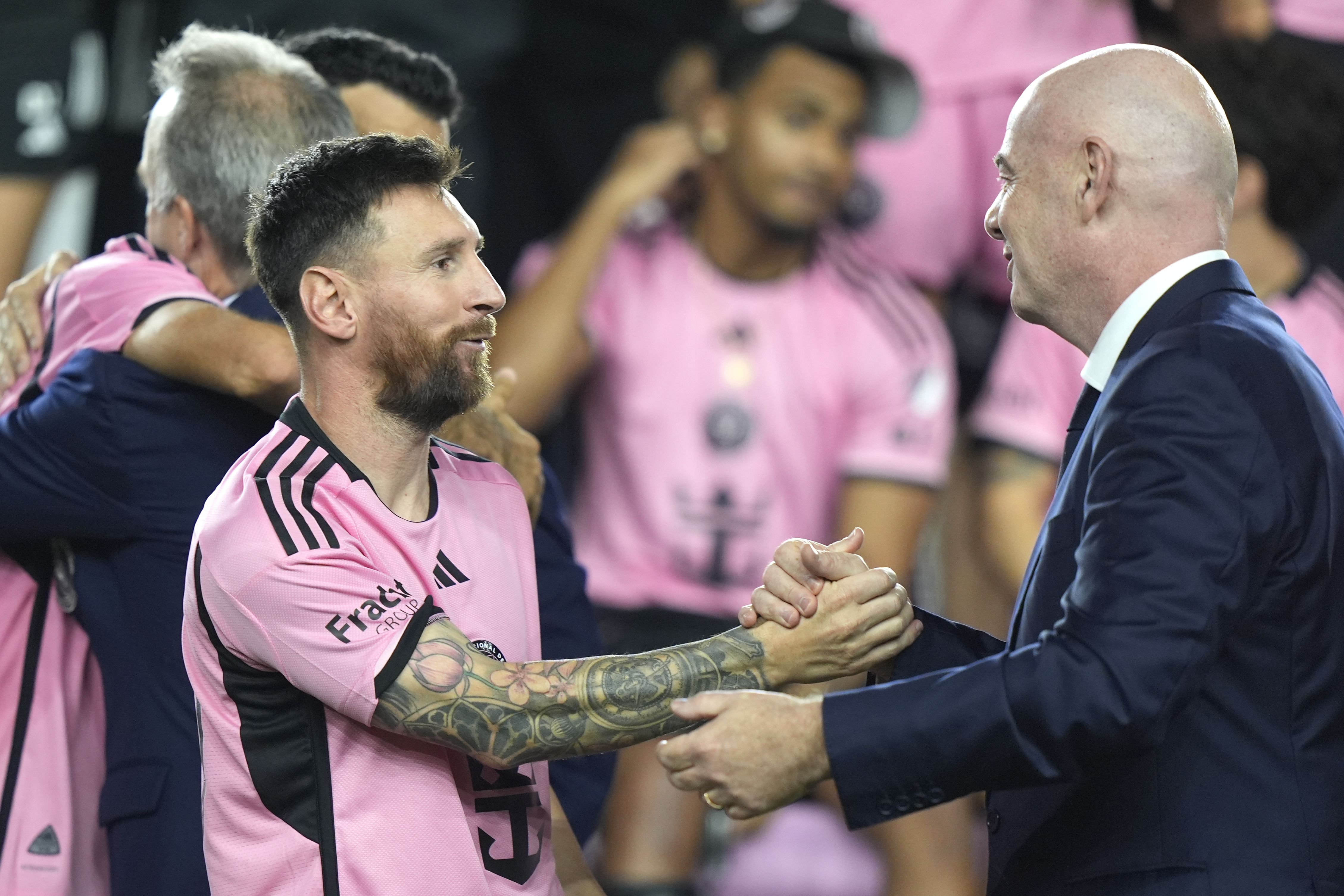 Inter Miami forward Lionel Messi, left, shakes hands with FIFA President Gianni Infantino, right, during a ceremony for the team winning the Supporters' Shield after an MLS soccer match against the New England Revolution, Saturday, Oct. 19, 2024, in Fort Lauderdale, Fla.
