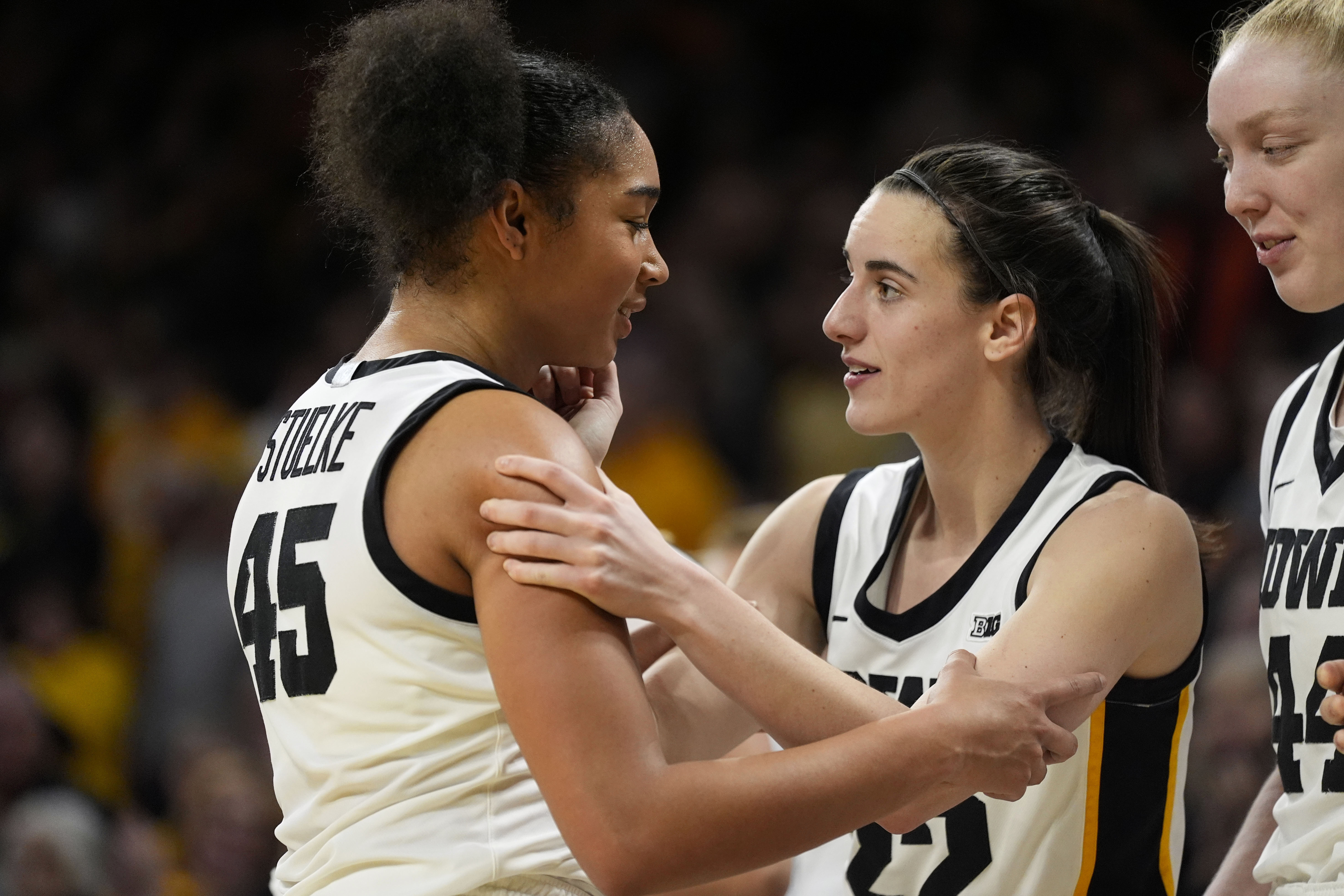 FILE - Iowa forward Hannah Stuelke, left, celebrates with teammate guard Caitlin Clark, during the second half of an NCAA college basketball game against Penn State, Feb. 8, 2024, in Iowa City, Iowa. 