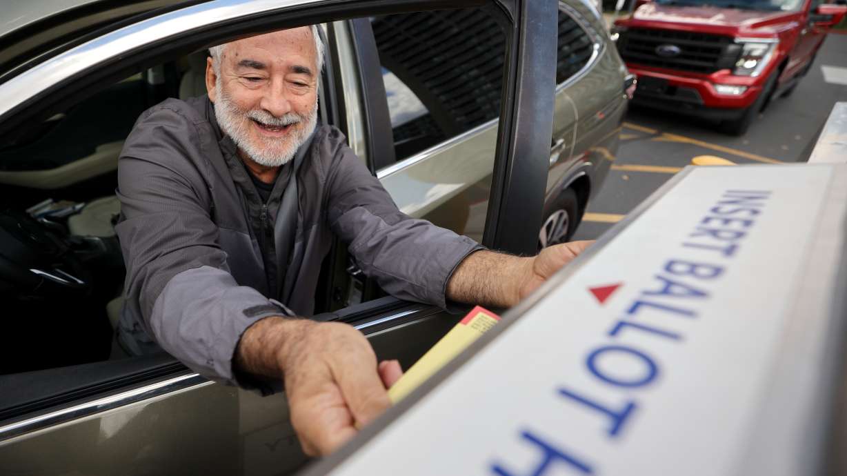 Peter Wilensky drops off his ballot during early voting outside the Salt Lake County Government Center in Salt Lake City on Wednesday.