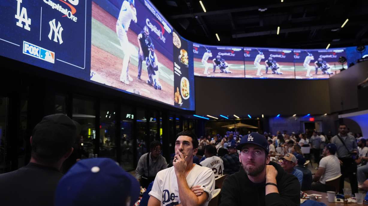 Fans watch a broadcast of Game 4 of the baseball World Series between the Los Angeles Dodgers and the New York Yankees at Cosm in Inglewood, Calif., Tuesday, Oct. 29, 2024.