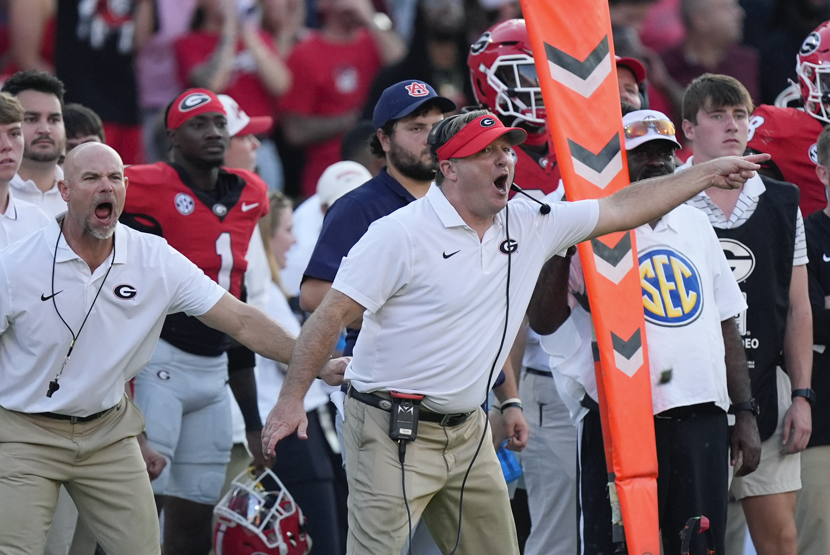 Georgia head coach Kirby Smart is restrained by another coach as he yells to his players on the field in the second half of an NCAA college football game against Auburn Saturday, Oct. 5, 2024, in Athens, Ga. 