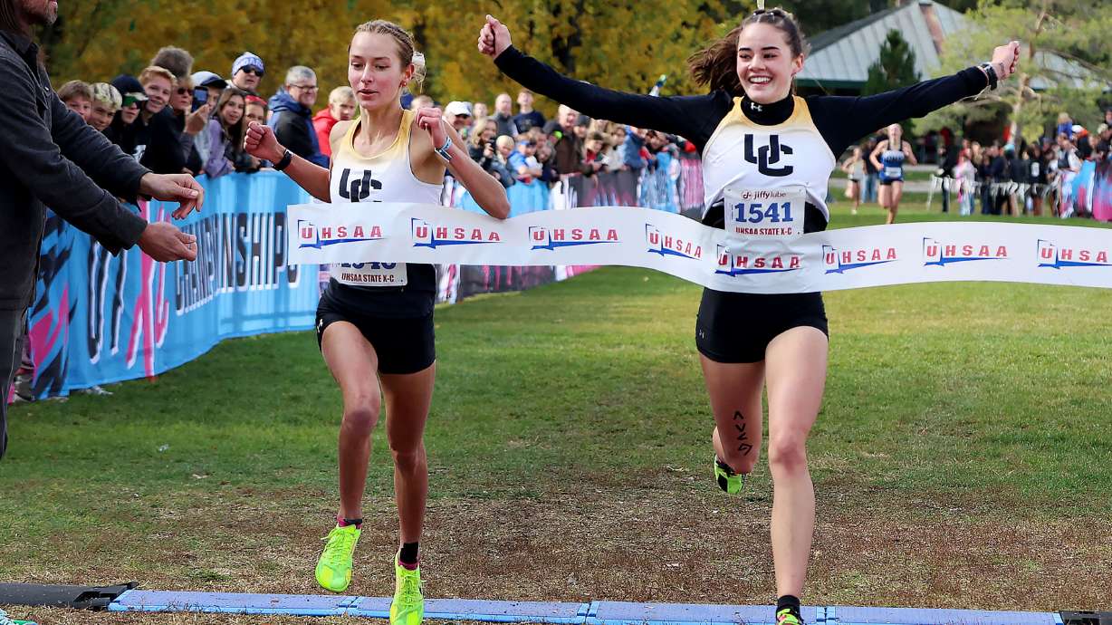 Jaylie Jenkins,right, and River White of Union High School, cross the line 1-2 in the 3A cross-country state championships at Sugar House Park in Salt Lake City on Wednesday, Oct. 30, 2024.