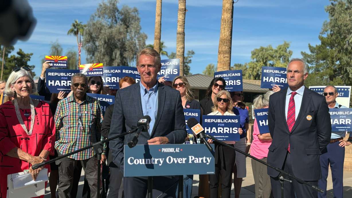 Former U.S. Ambassador to Turkey Jeff Flake, Scottsdale mayor Sam Campana, Mesa Mayor John Giles and businessman Tim Riester gave remarks at a Get Out and Vote event for the Harris-Walz campaign outside an early voting center in Scottsdale, Ariz., on Wednesday. Flake has endorsed Kamala Harris in the presidential race.