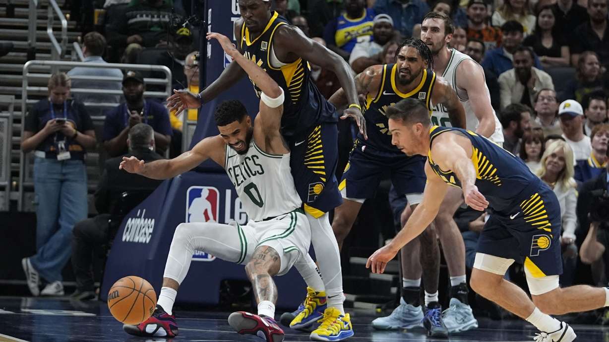 Boston Celtics' Jayson Tatum (0) looses control of the ball against Indiana Pacers' Pascal Siakam (43) and T.J. McConnell (9) during the second half of an NBA basketball game, Wednesday, Oct. 30, 2024, in Indianapolis.