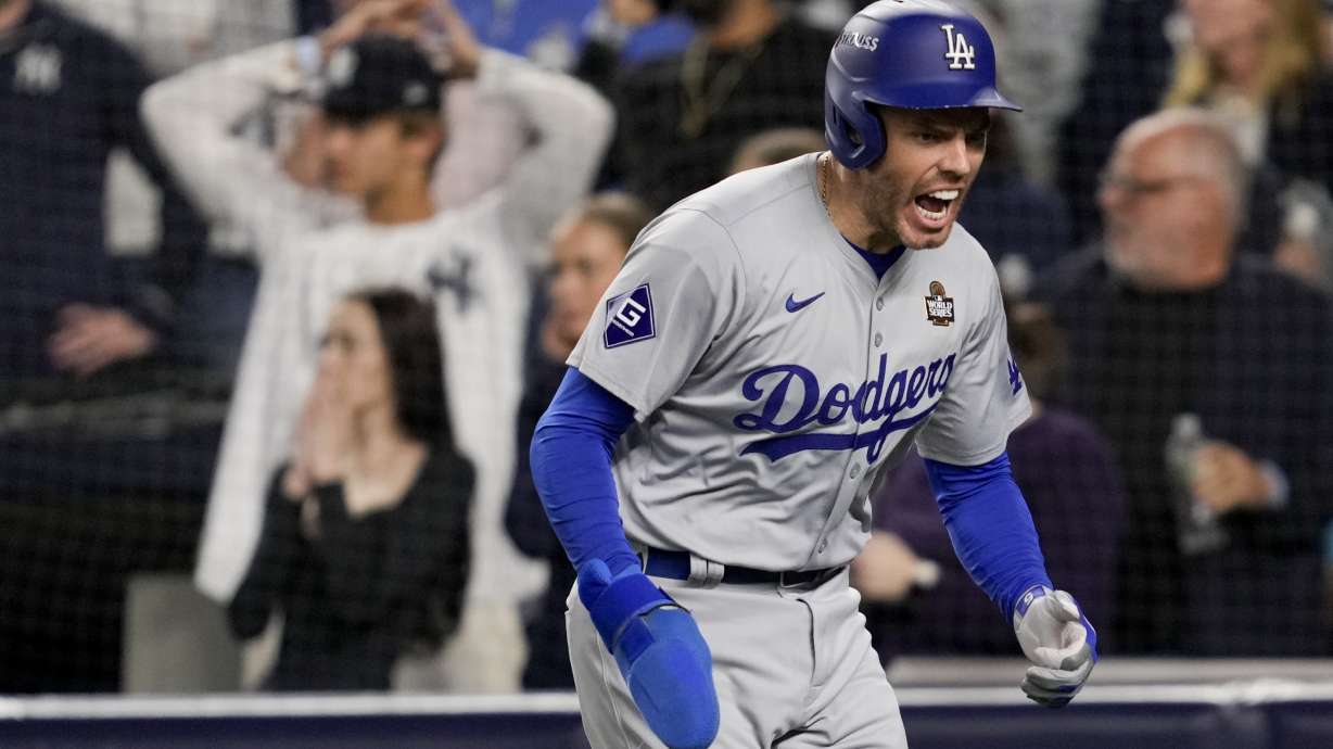 Los Angeles Dodgers' Freddie Freeman celebrates after scoring on a double by Teoscar Hernández during the fifth inning in Game 5 of the baseball World Series, Wednesday, Oct. 30, 2024, in New York.